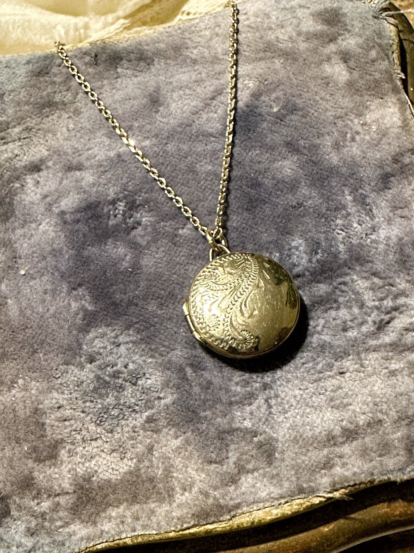 A beautiful vintage gold plated engraved locket and chain