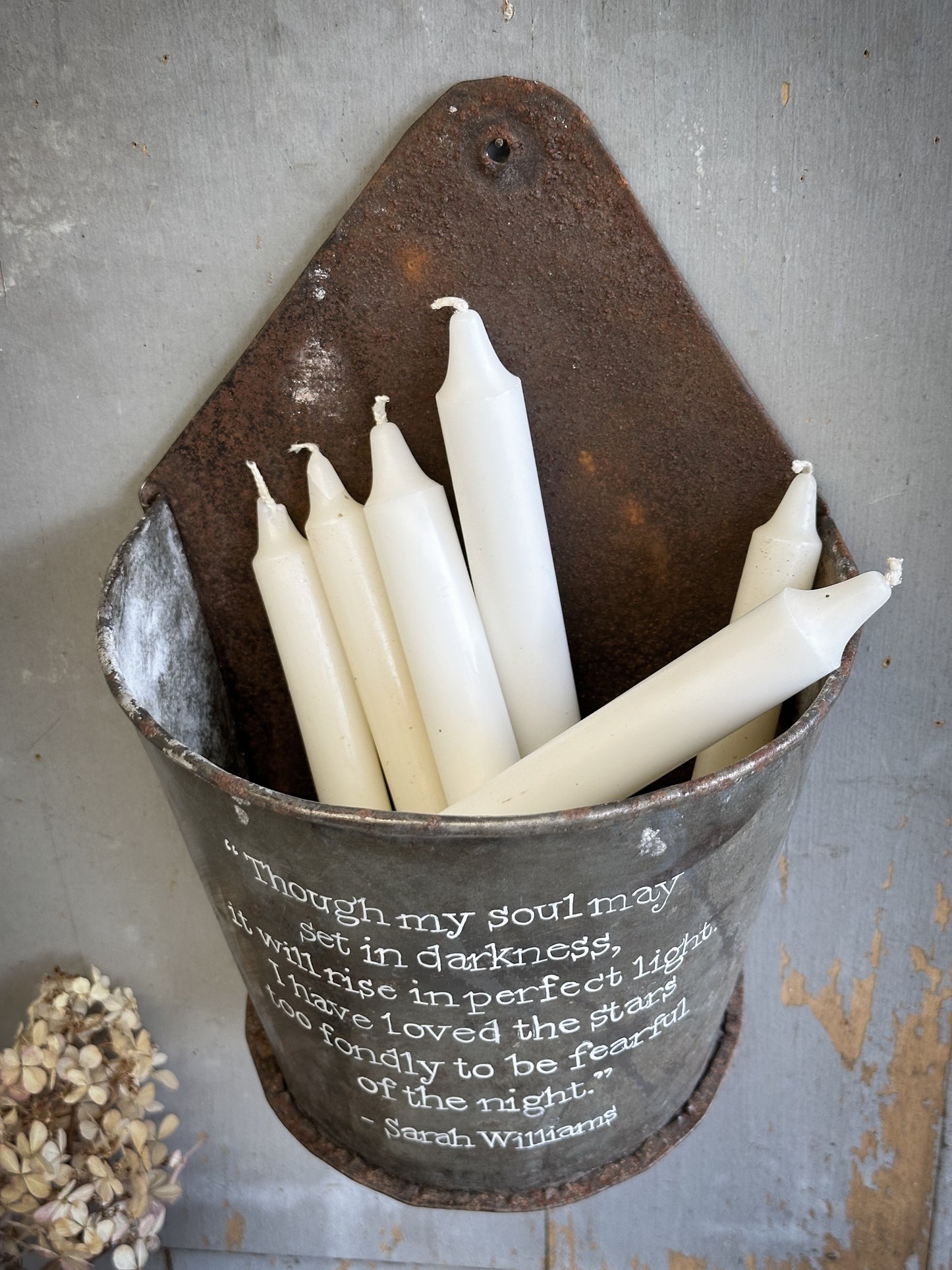 A Recycled Metal Candle Store With A Hand Painted Quote