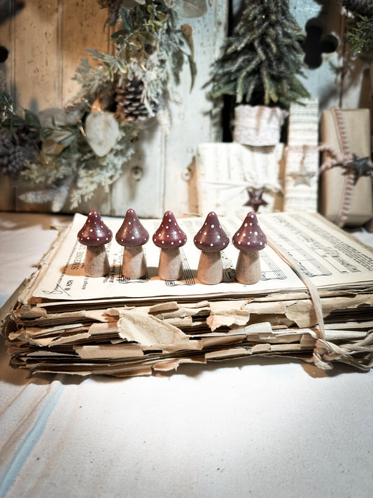 A wooden hand painted Christmas village toadstool