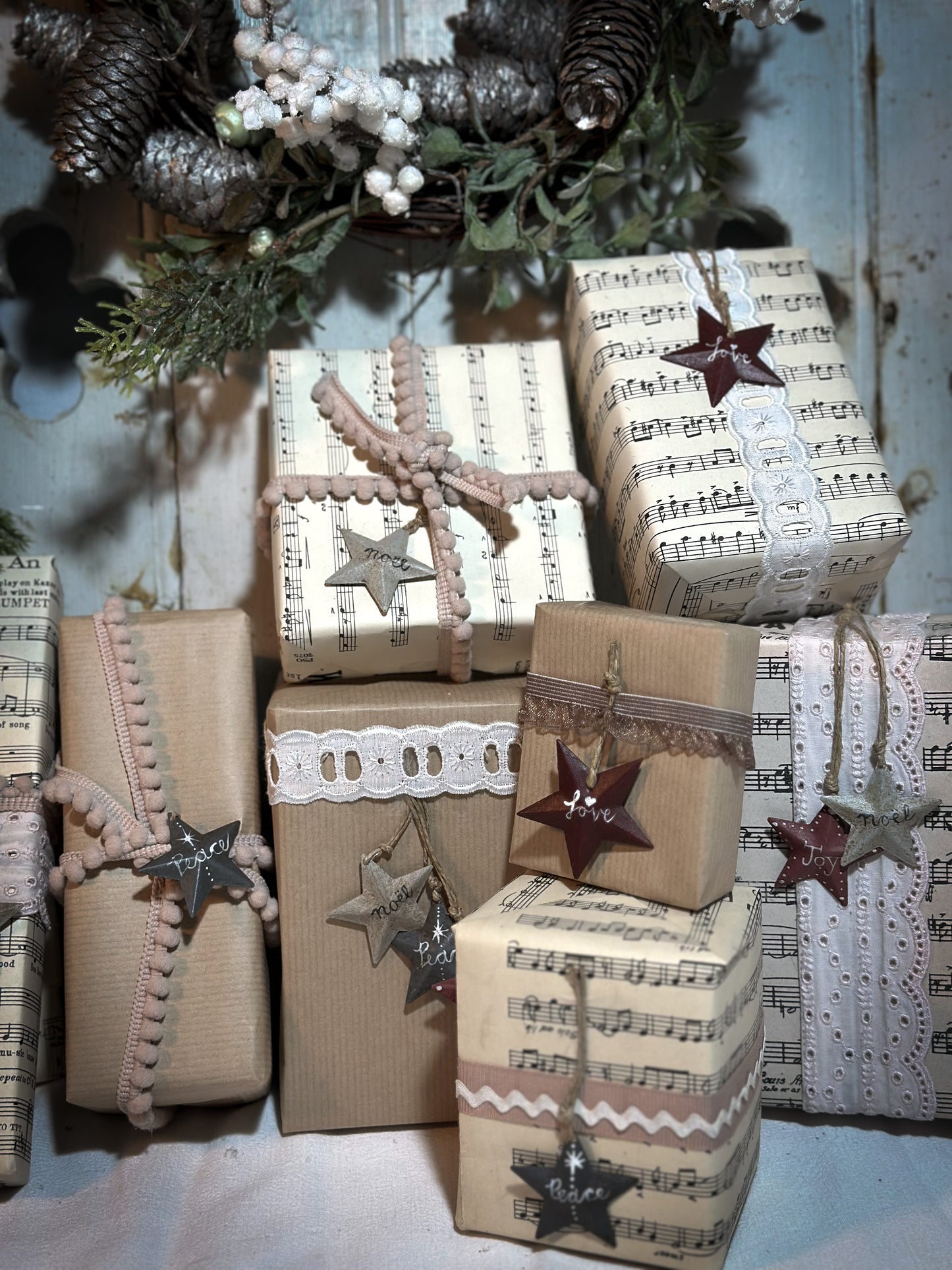 A mini tin barn star pink decoration hand painted with “Joy”