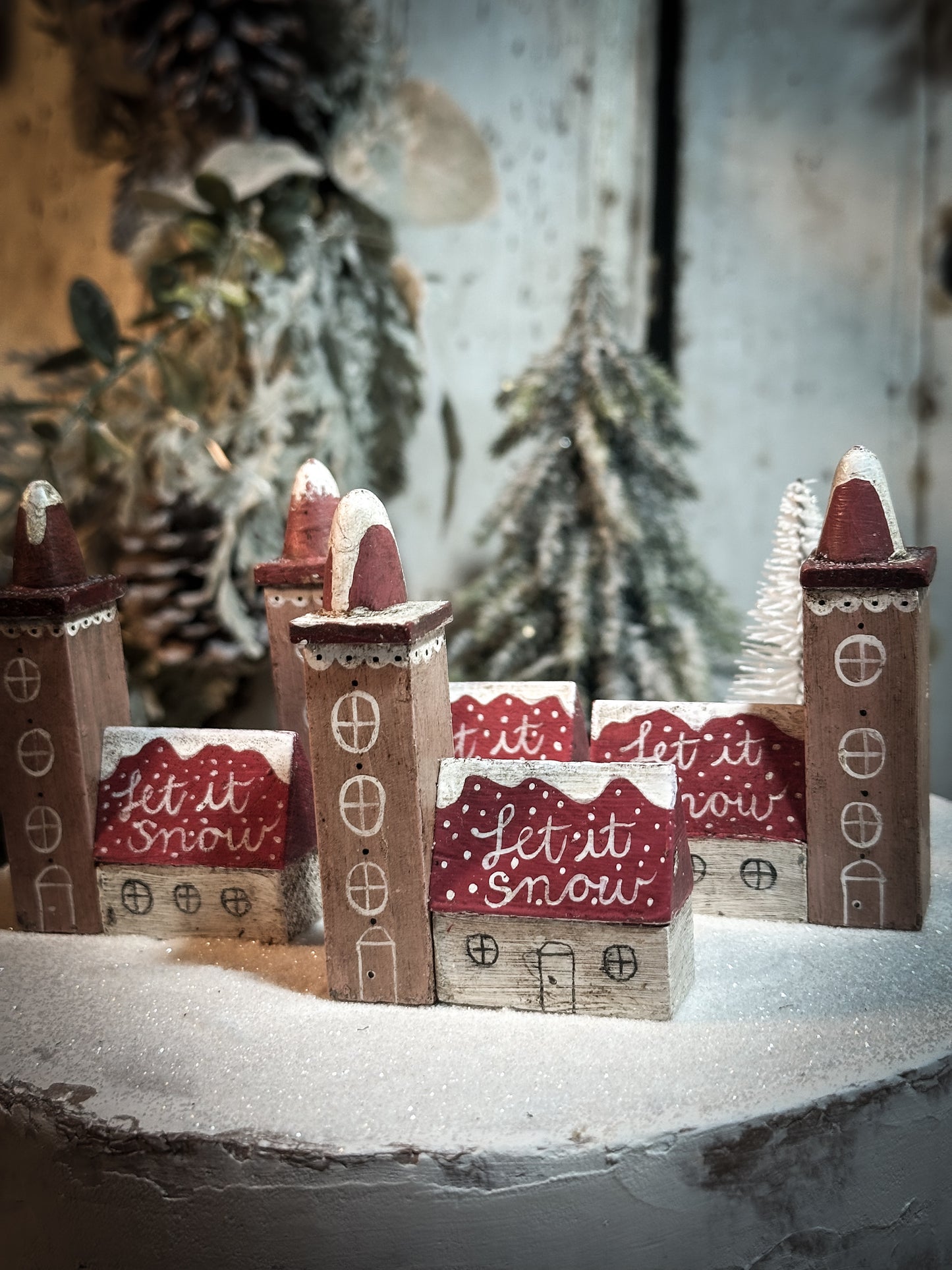 A pretty vintage German Erzgebirge Putz wooden village house painted with a Christmas quote