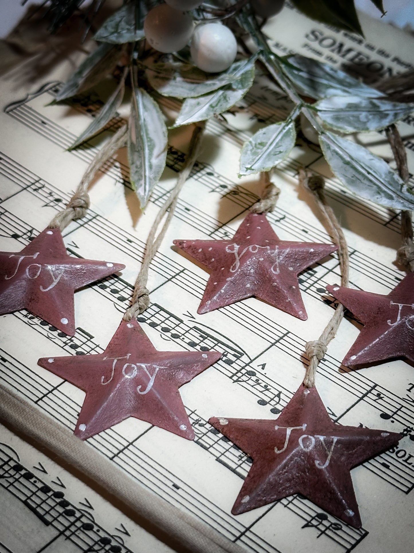 A mini tin barn star pink decoration hand painted with “Joy”