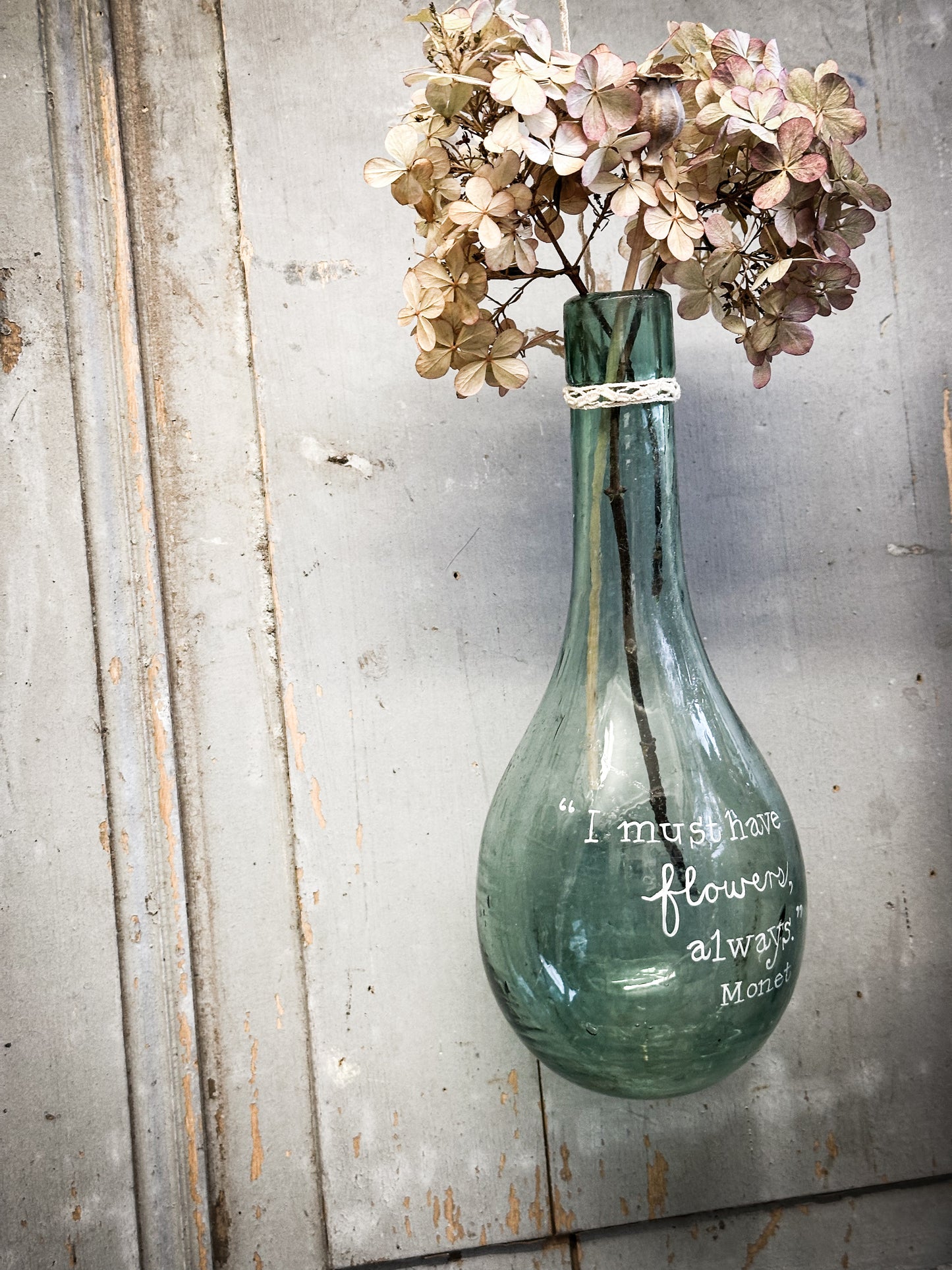A beautiful antique hanging bulb bottle with a hand painted quote