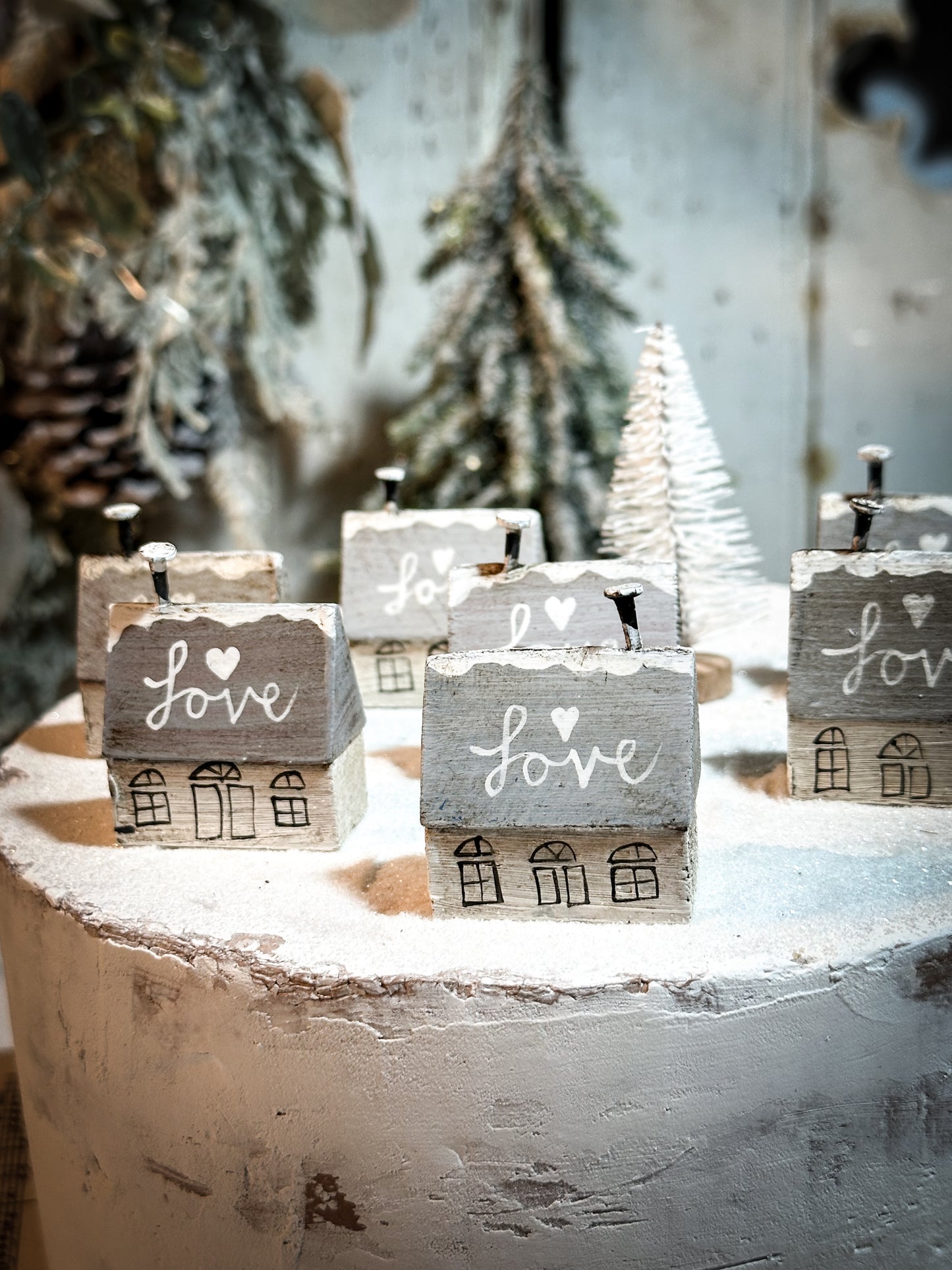 A pretty vintage German Erzgebirge Putz wooden village house painted with a Christmas quote