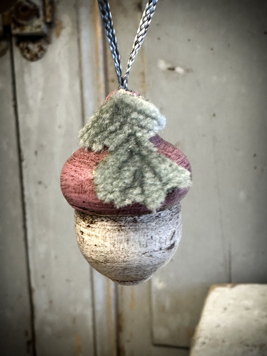 A wooden hand painted and trimmed Cranberry Acorn Decoration