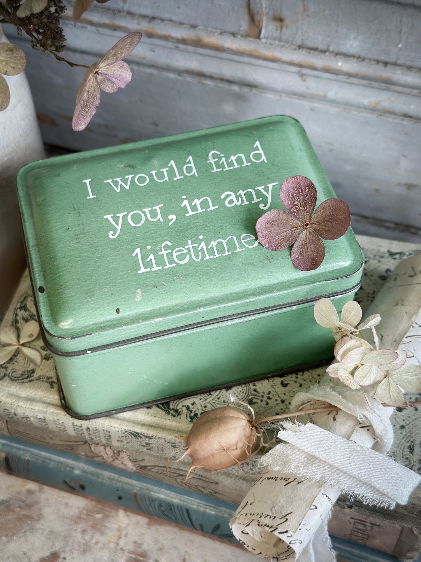 A Vintage Tin With A Hand Painted Quote