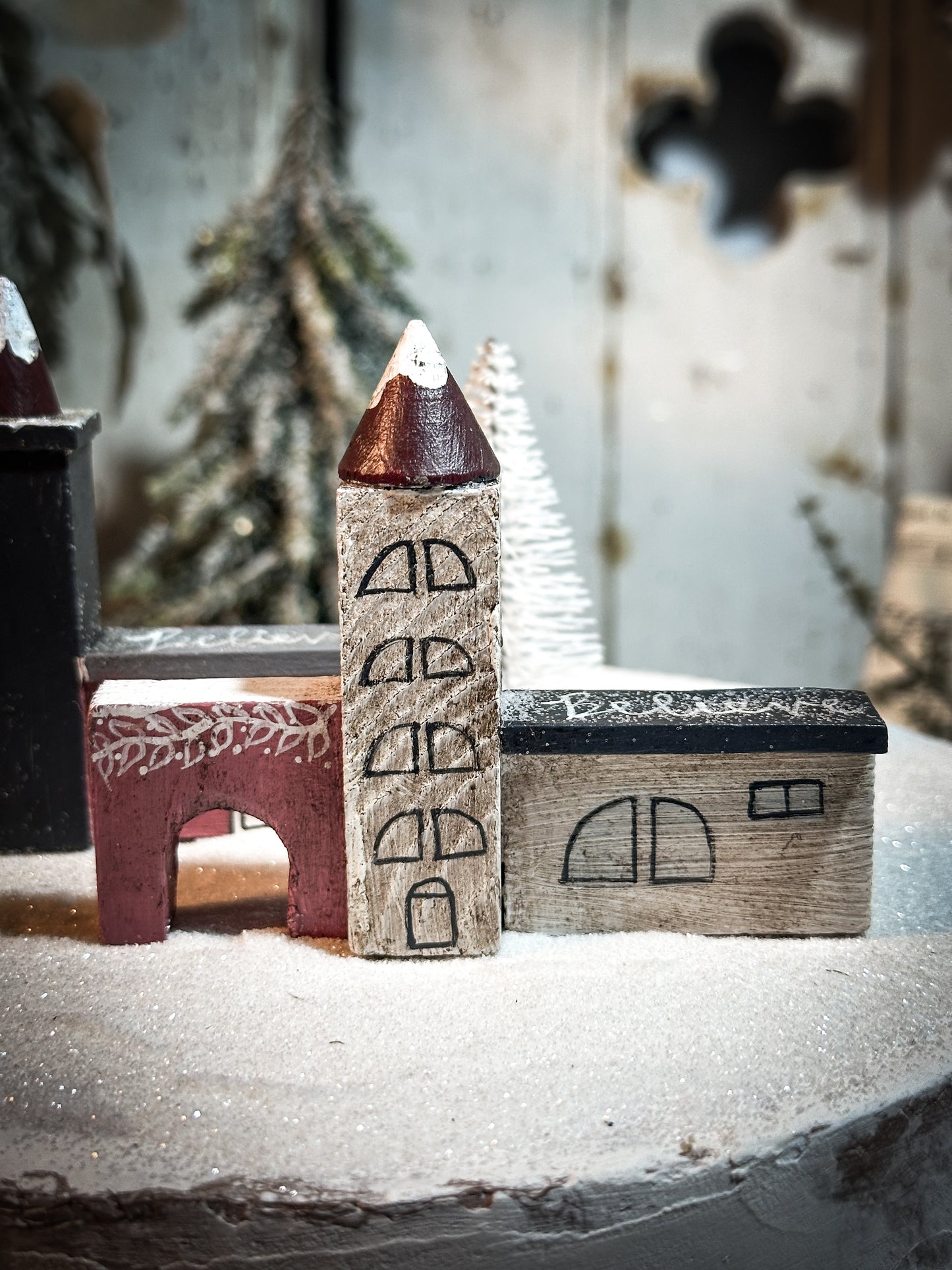 A pretty vintage German Erzgebirge Putz wooden village house painted with a Christmas quote