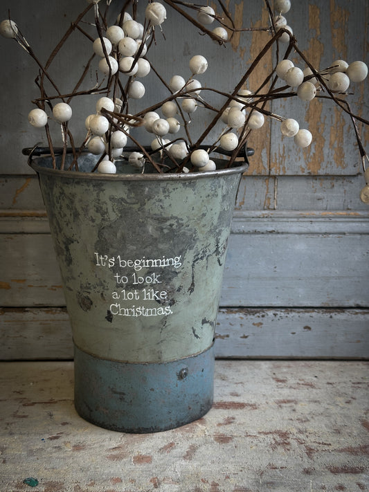 A Recycled Metal Mini Christmas Tree Bucket With A Hand Painted Quote