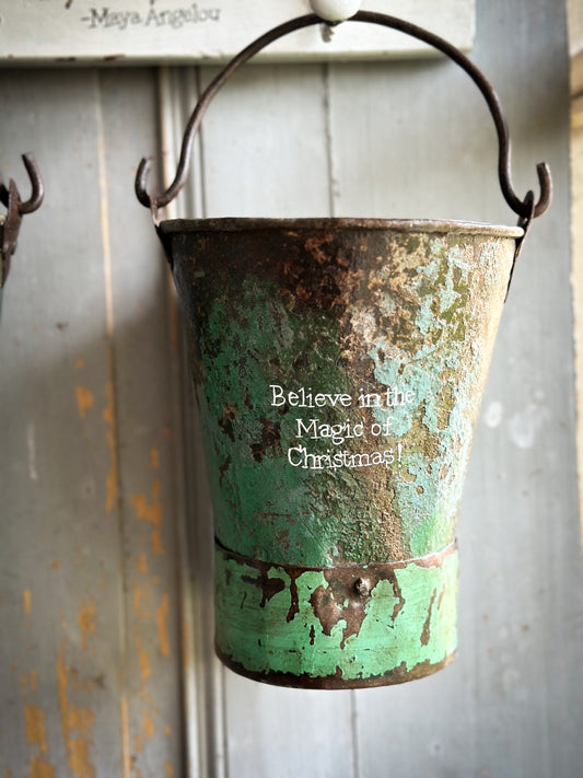 A Recycled Metal Mini Christmas Tree Bucket With A Hand Painted Quote