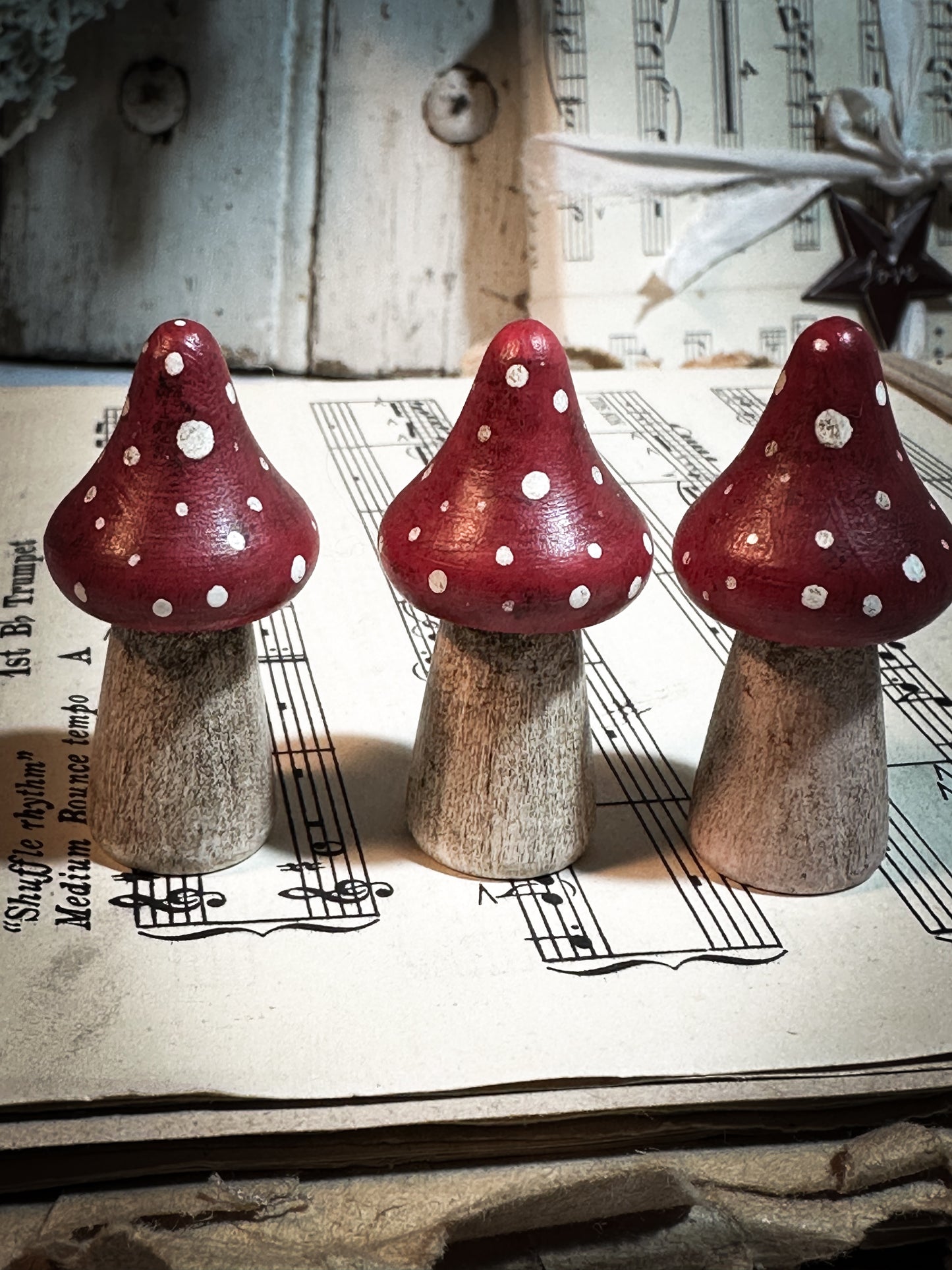 A wooden hand painted Christmas village toadstool