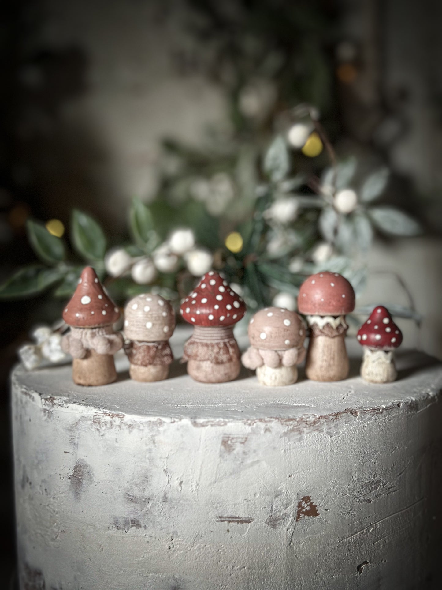 A set of six wooden hand painted and trimmed Christmas village mushrooms