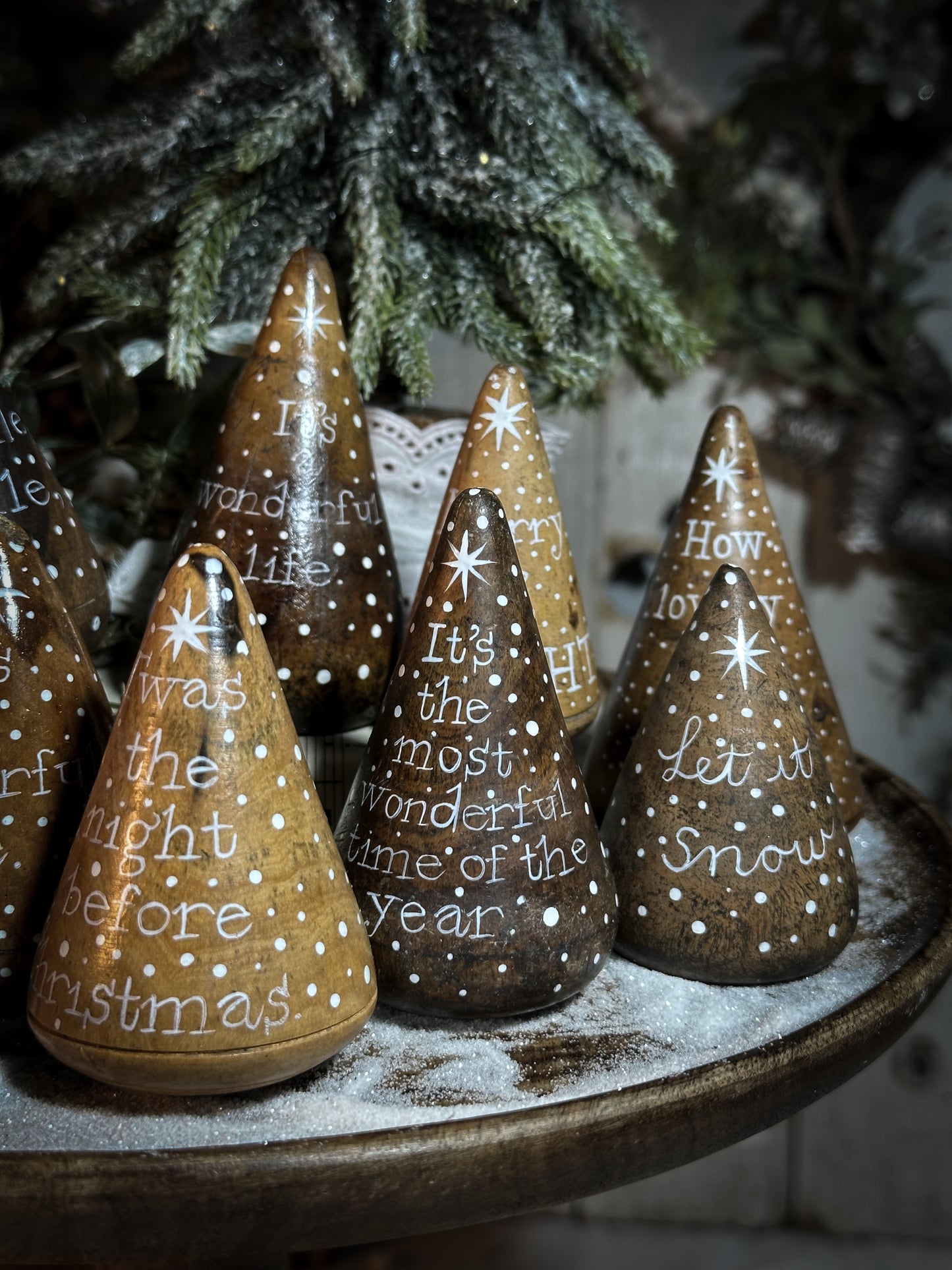 A hand painted quote on a lignum vitae wood plumber’s turnpin with a Christmas quote