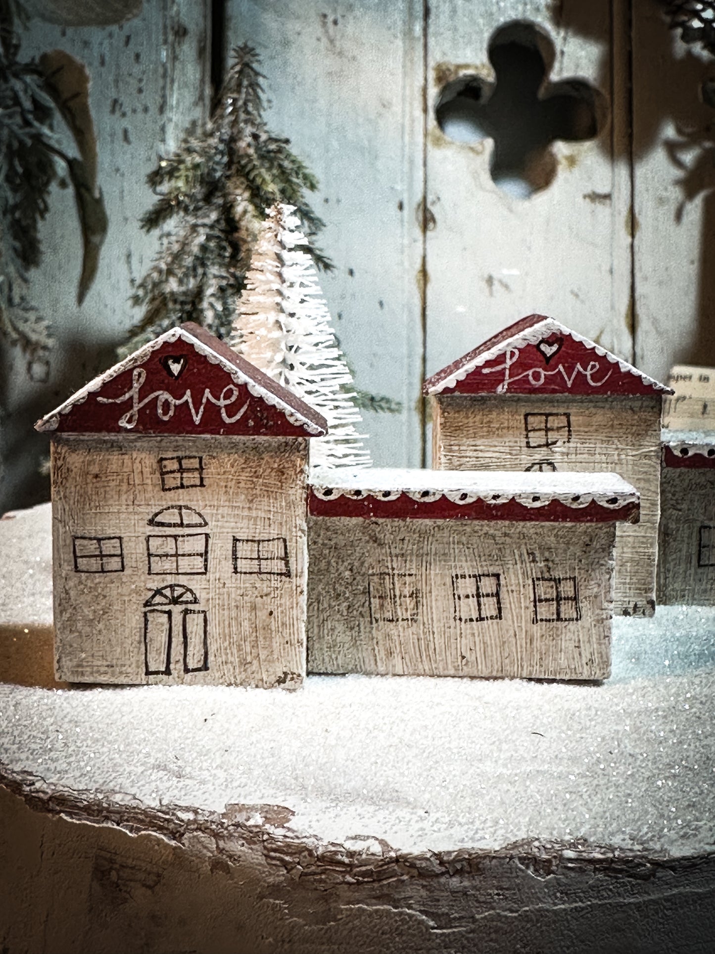 A pretty vintage German Erzgebirge Putz wooden village house painted with a Christmas quote