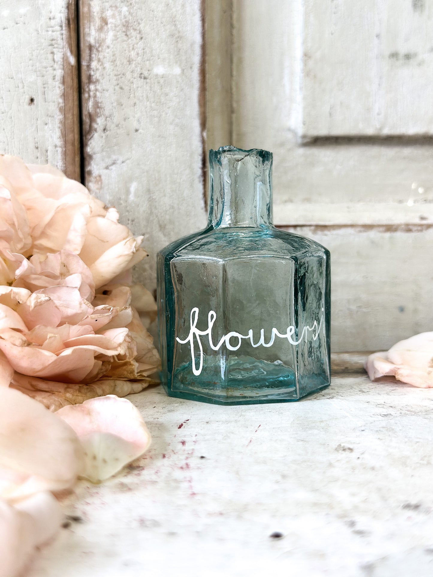 A beautiful Victorian bottle with a hand painted quote “Flowers”