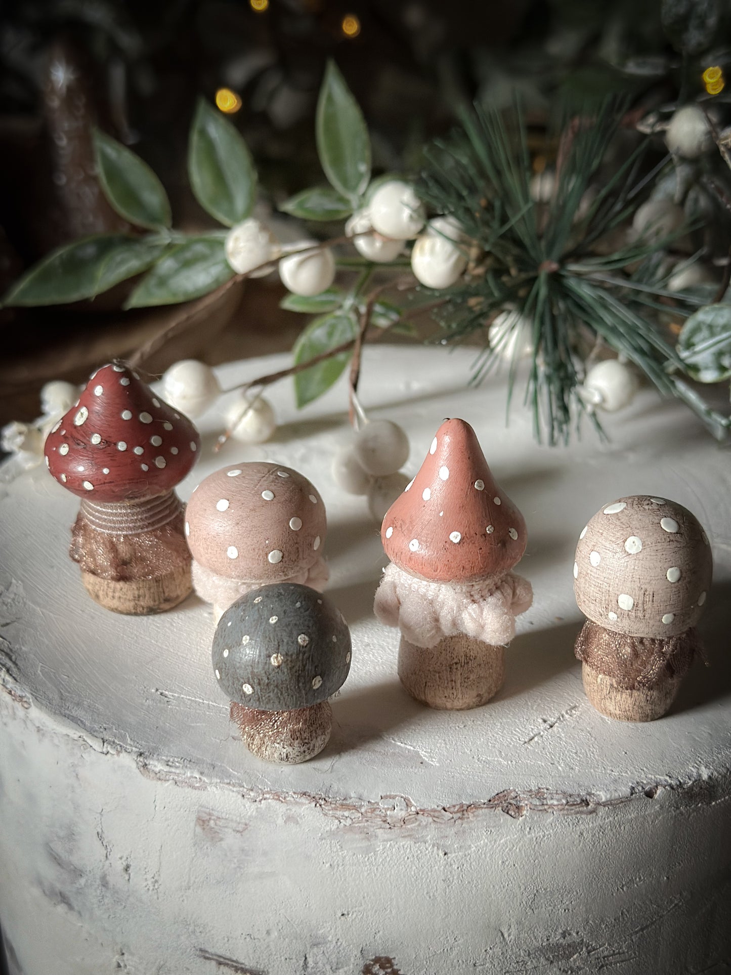 A set of five wooden hand painted and trimmed Christmas village toadstools