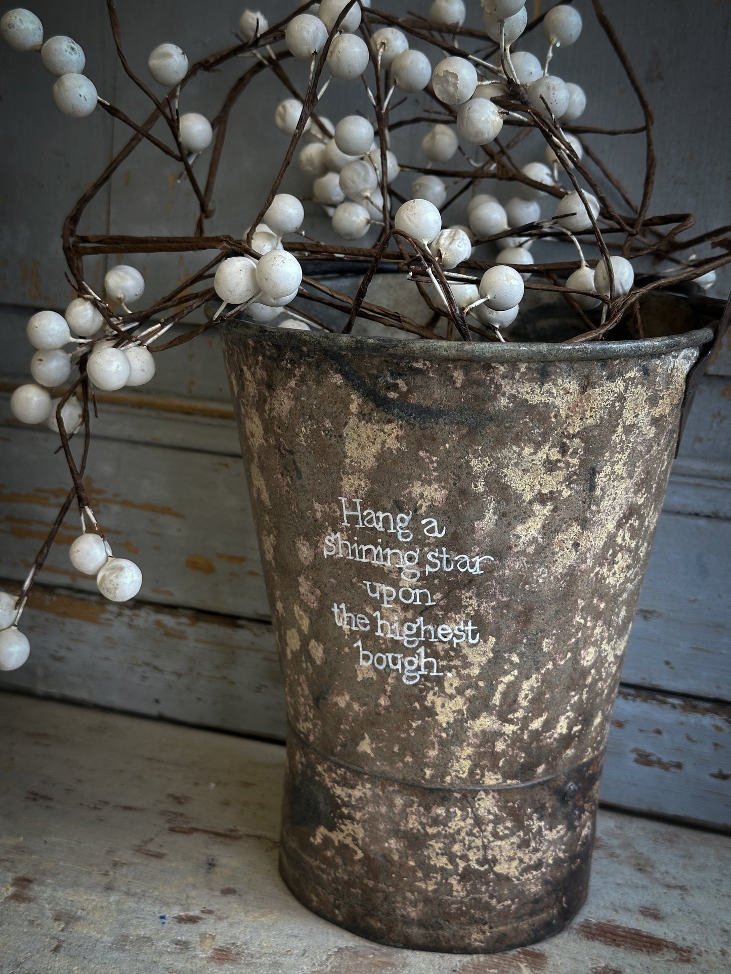 A Recycled Metal Mini Christmas Tree Bucket With A Hand Painted Quote