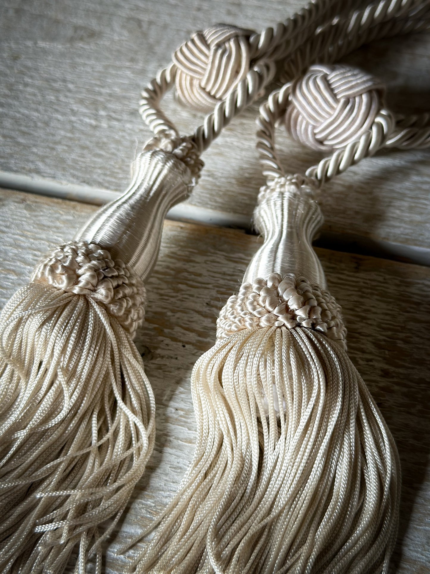 A pair of pretty vintage ivory curtain tie backs