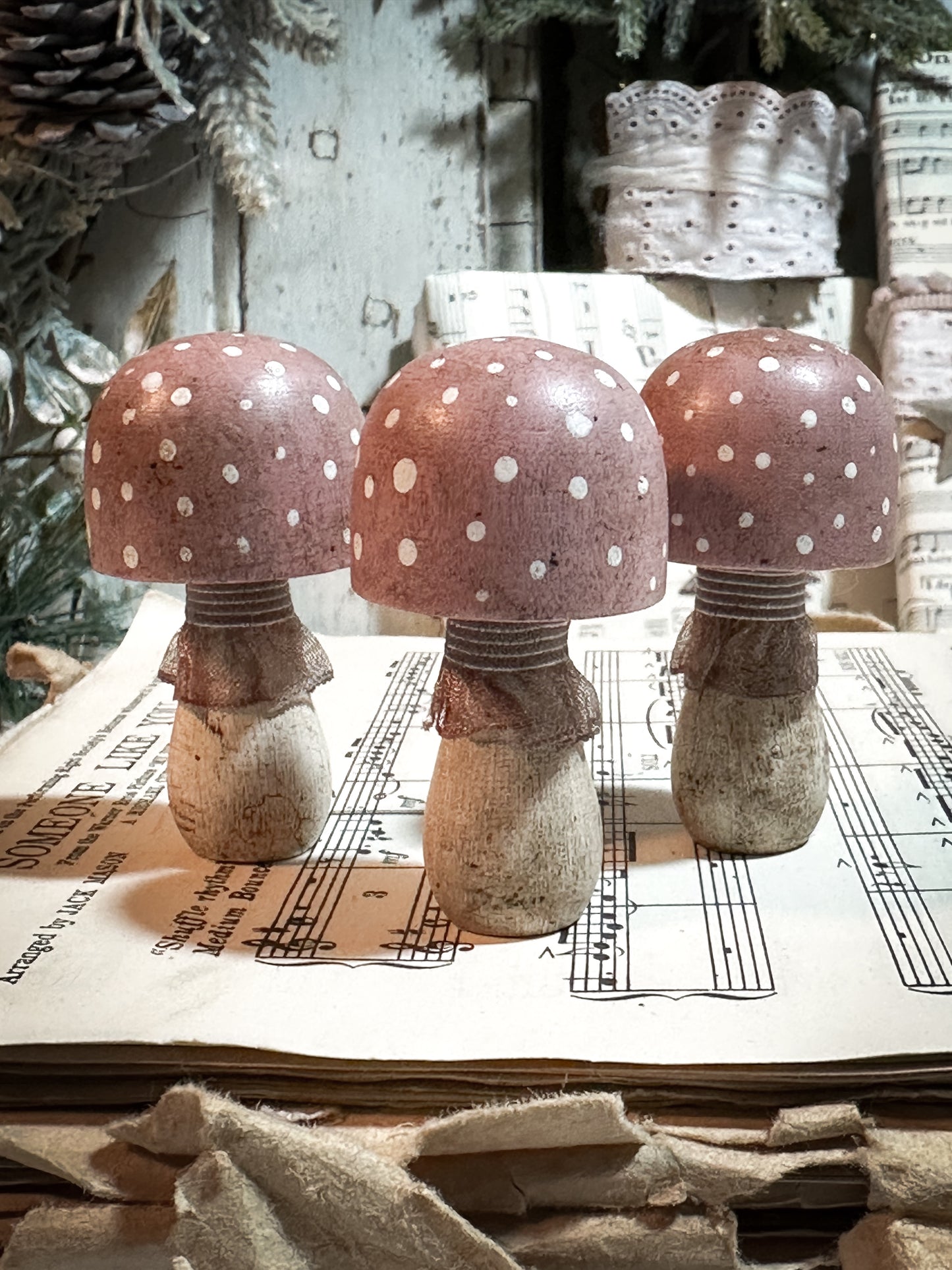 A wooden hand painted and trimmed Christmas village toadstool