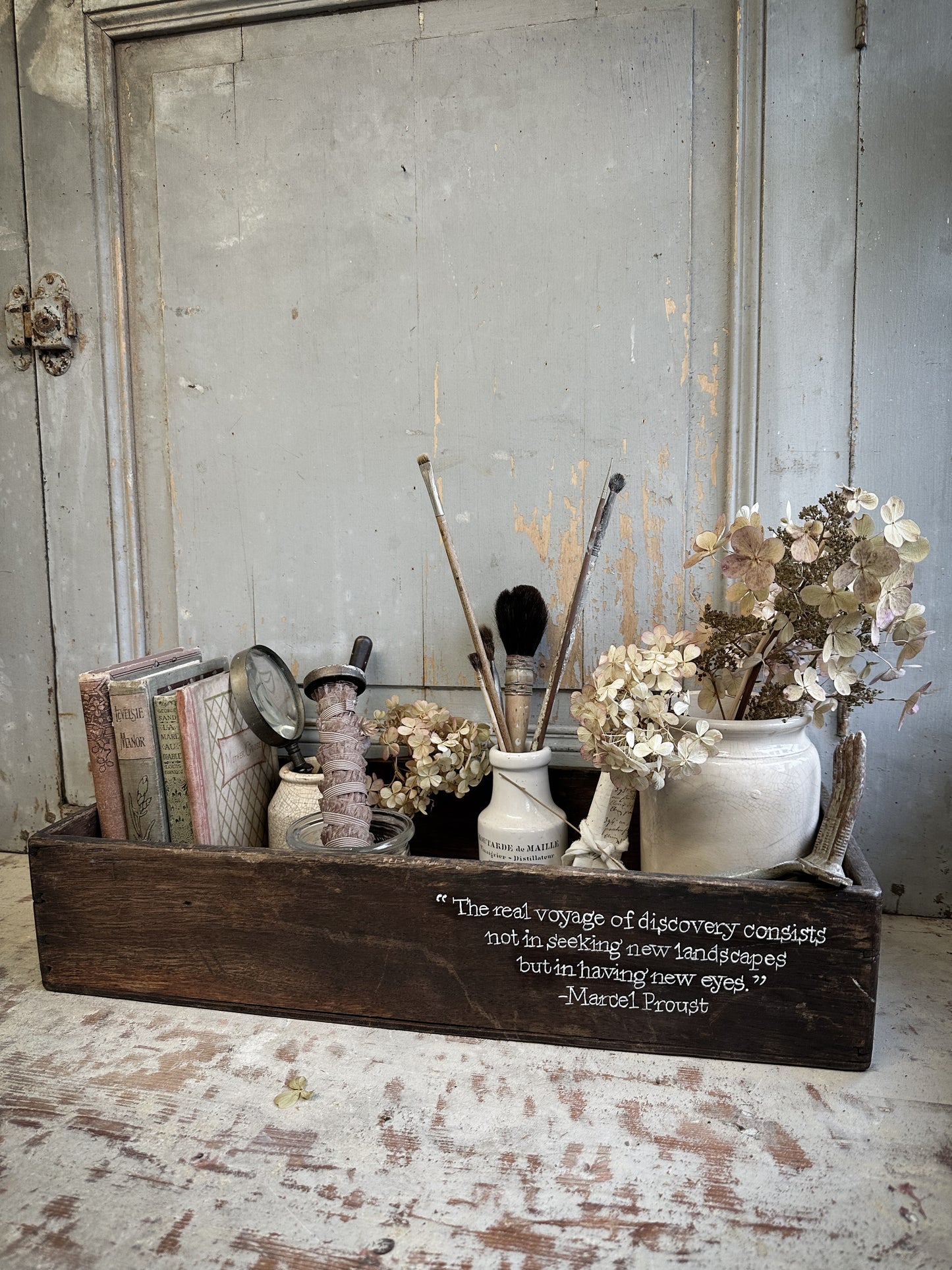 A Vintage Wooden Crate With Hand Painted Quote