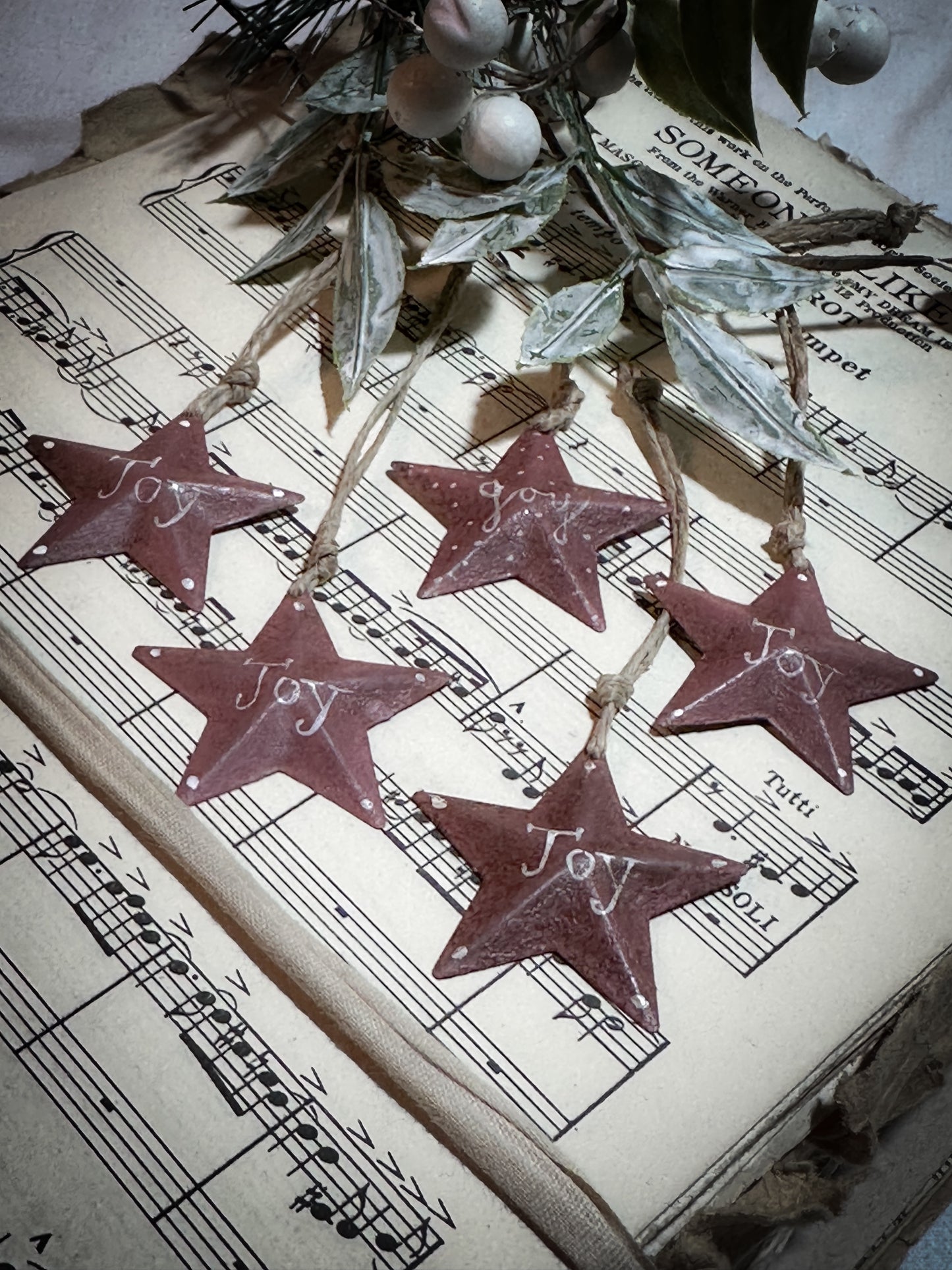 A mini tin barn star pink decoration hand painted with “Joy”