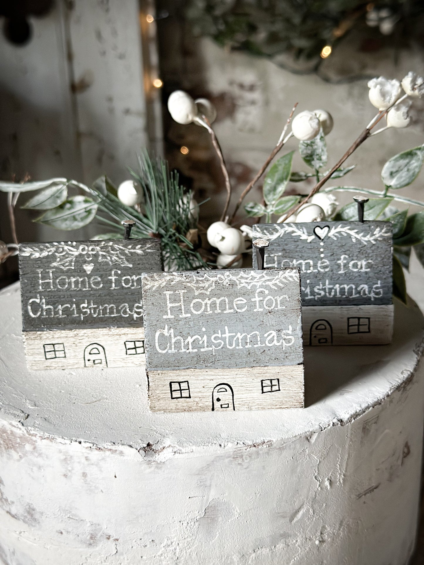 A pretty vintage German Erzgebirge Putz wooden village house painted with a Christmas quote