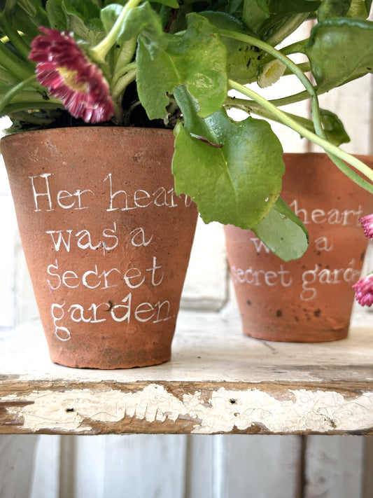 A Victorian terracotta pot with a quote “ Her heart was a Secret Garden”