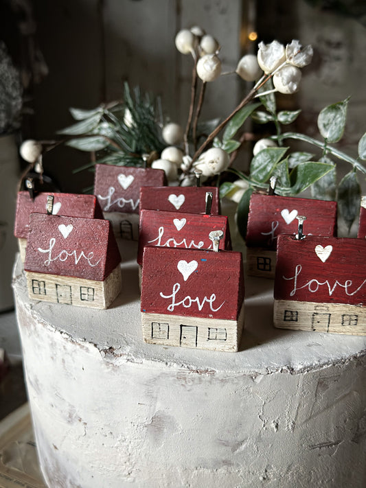 A pretty vintage German Erzgebirge Putz wooden village house painted with a Christmas quote