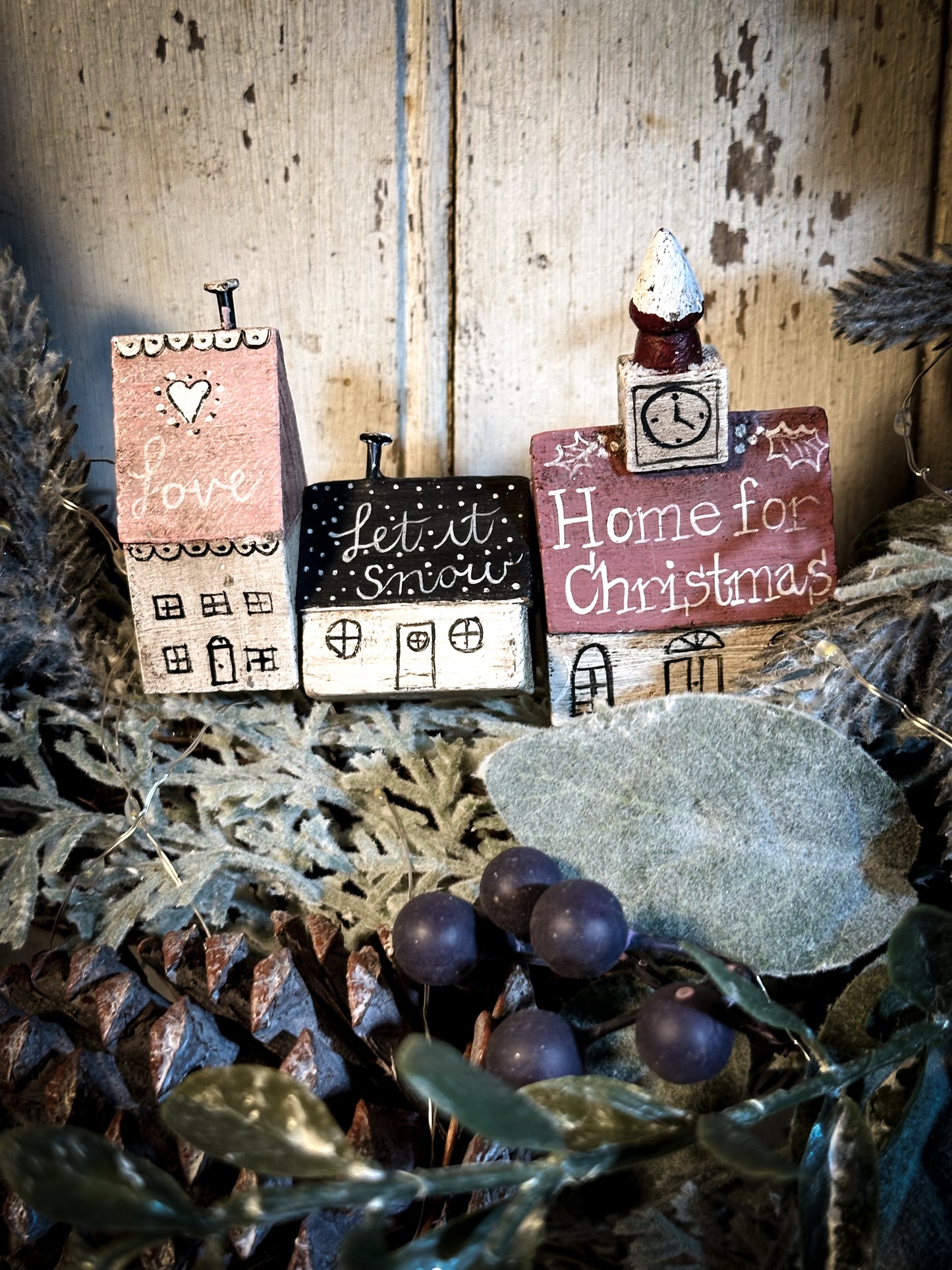 A pretty vintage German Erzgebirge Putz wooden village house painted with a Christmas quote