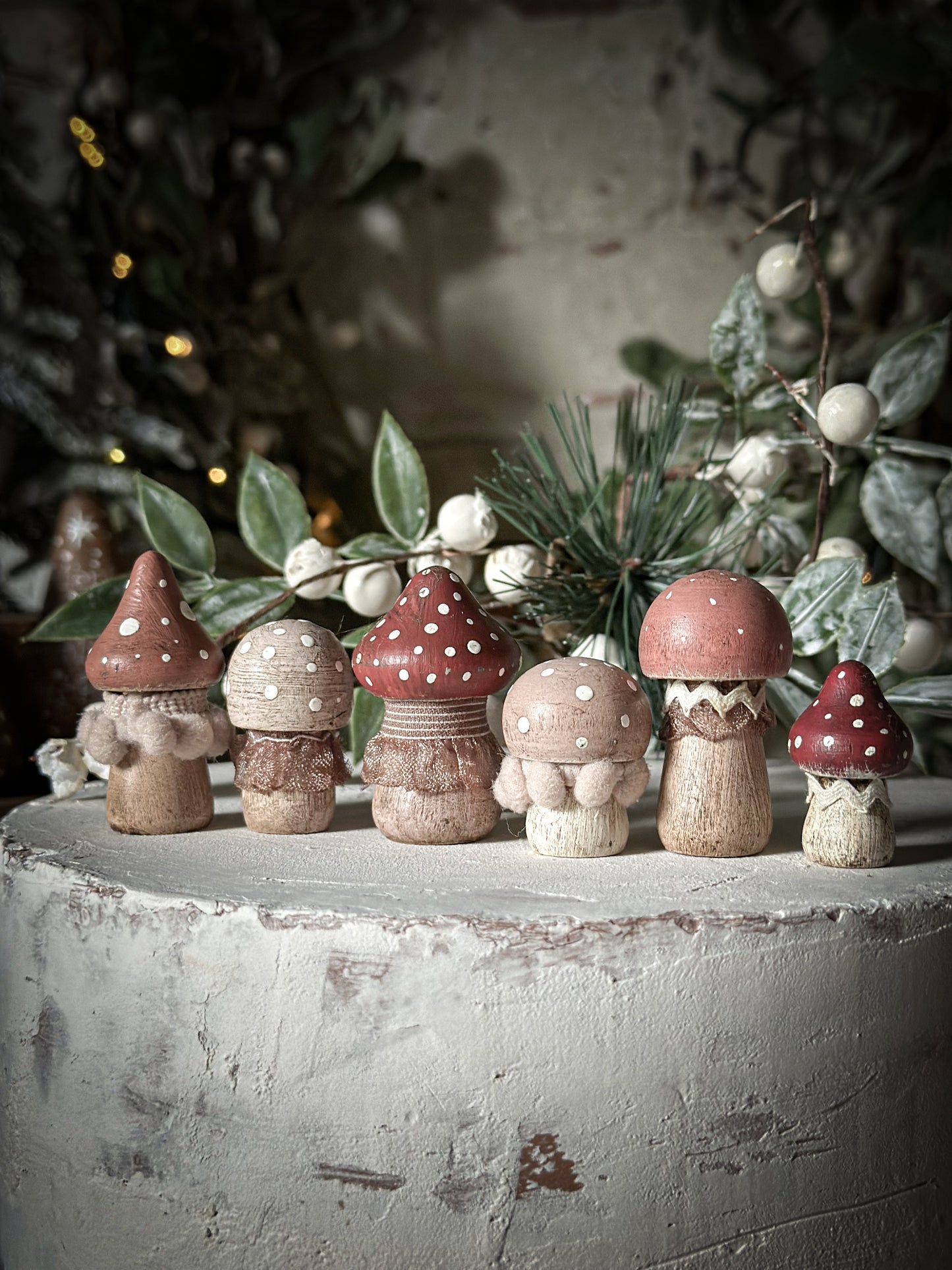 A set of six wooden hand painted and trimmed Christmas village mushrooms