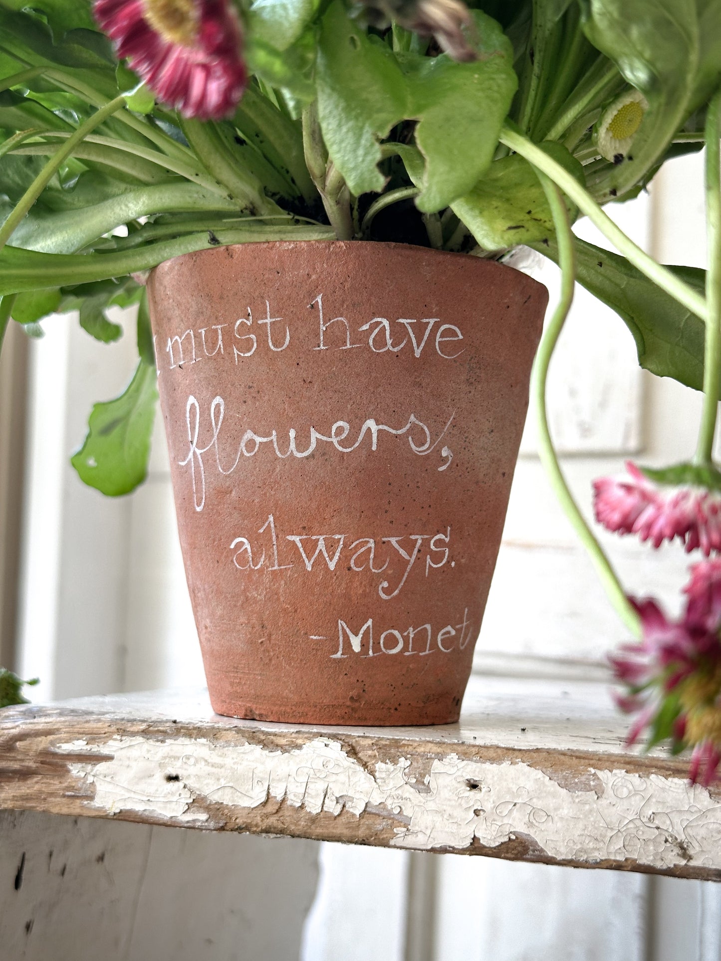 A Victorian terracotta pot with a quote “I must have flowers”