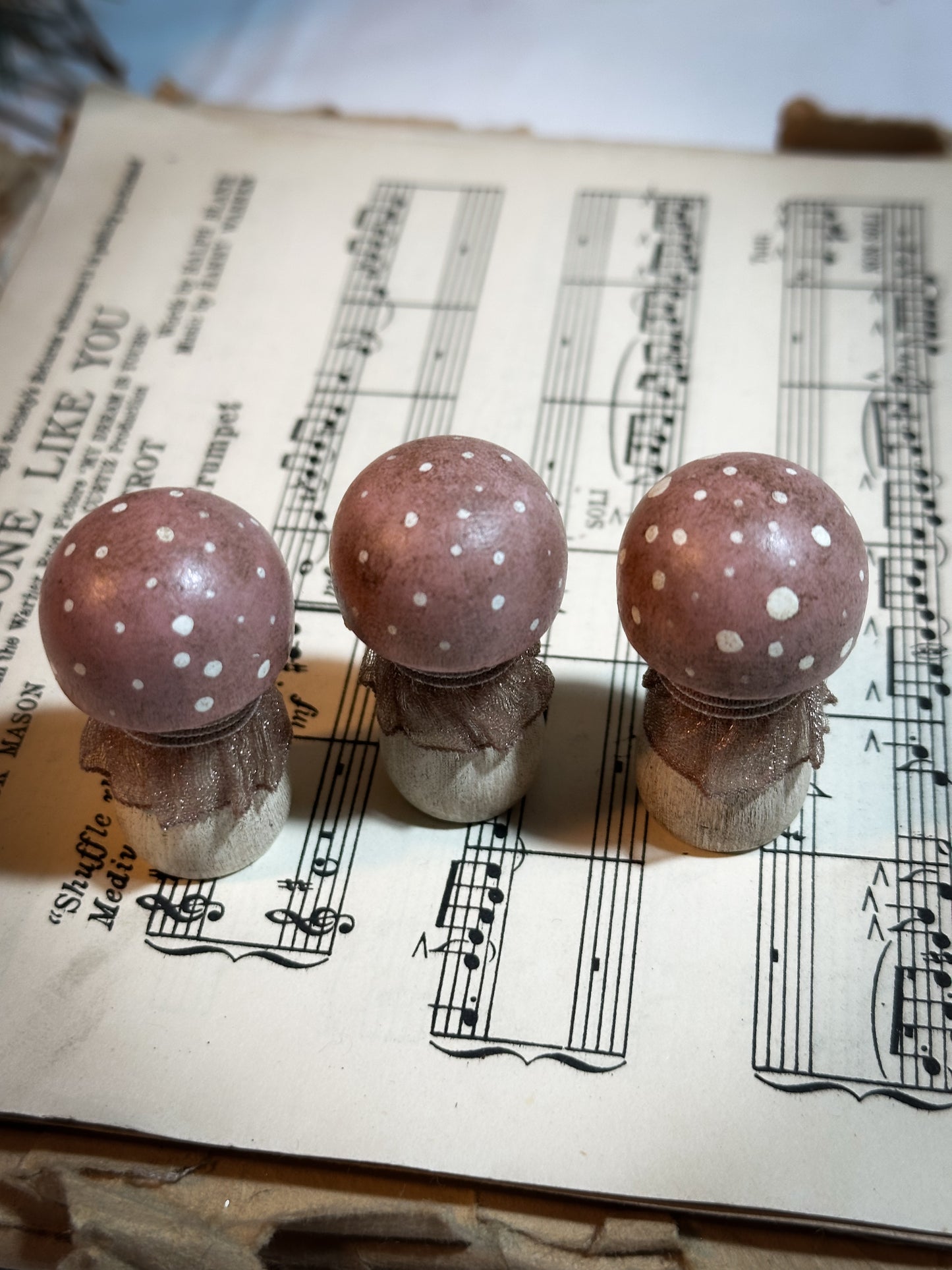 A wooden hand painted and trimmed Christmas village toadstool