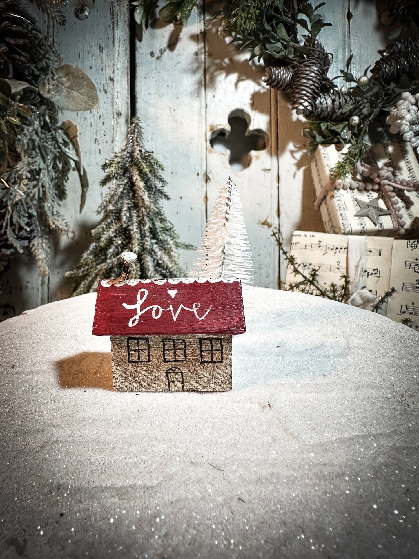 A pretty vintage German Erzgebirge Putz wooden log cabin painted with a Christmas quote