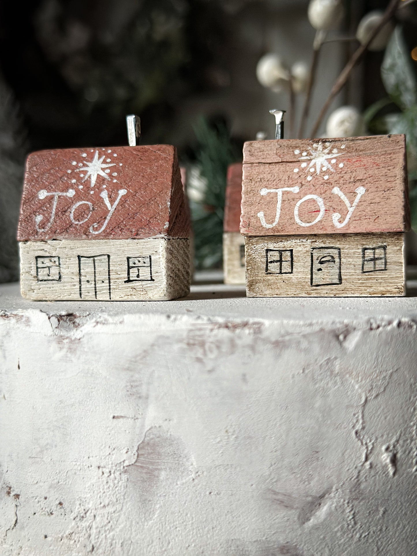 A pretty vintage German Erzgebirge Putz wooden village house painted with a Christmas quote