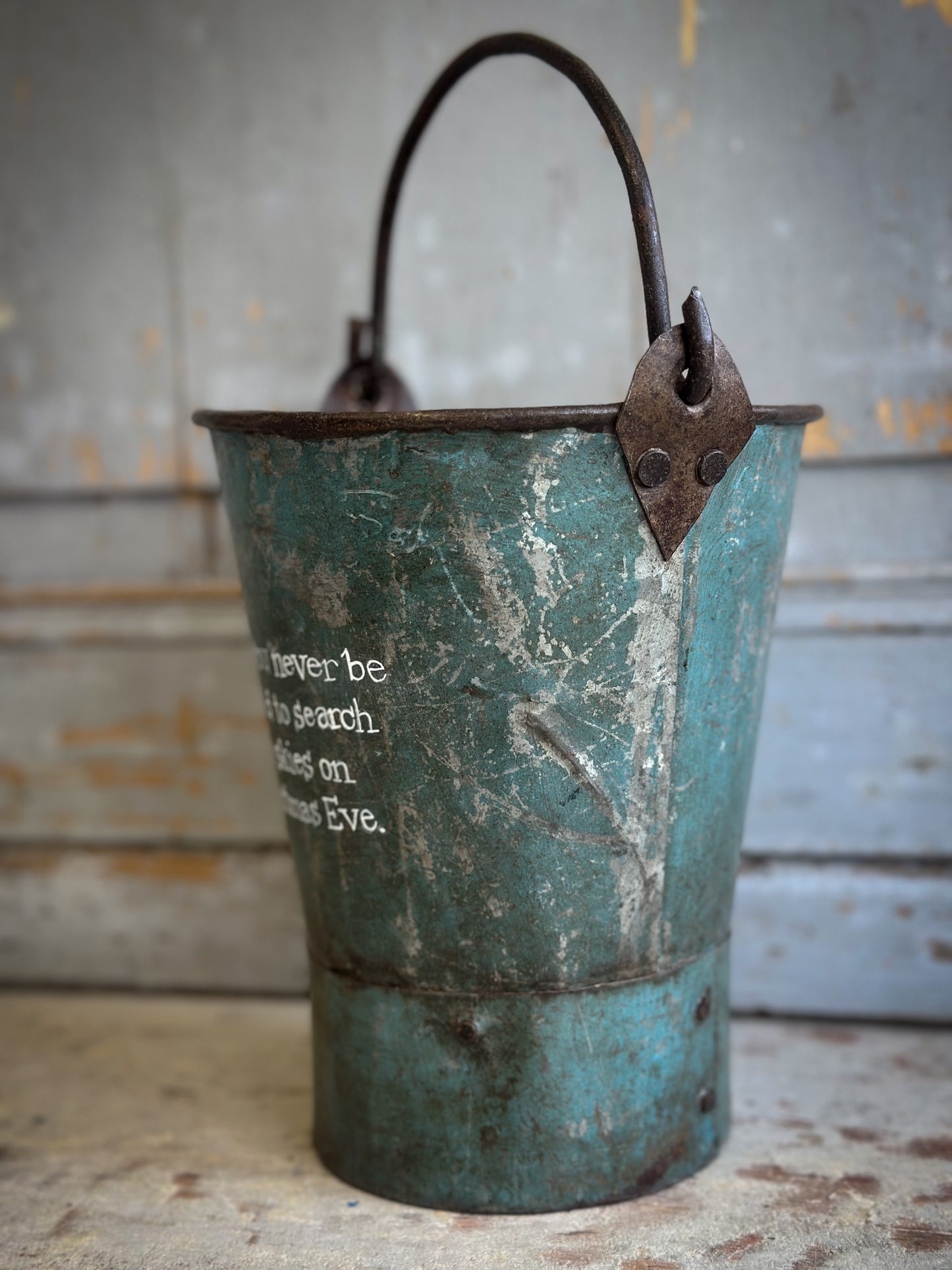 A Recycled Metal Mini Christmas Tree Bucket With A Hand Painted Quote