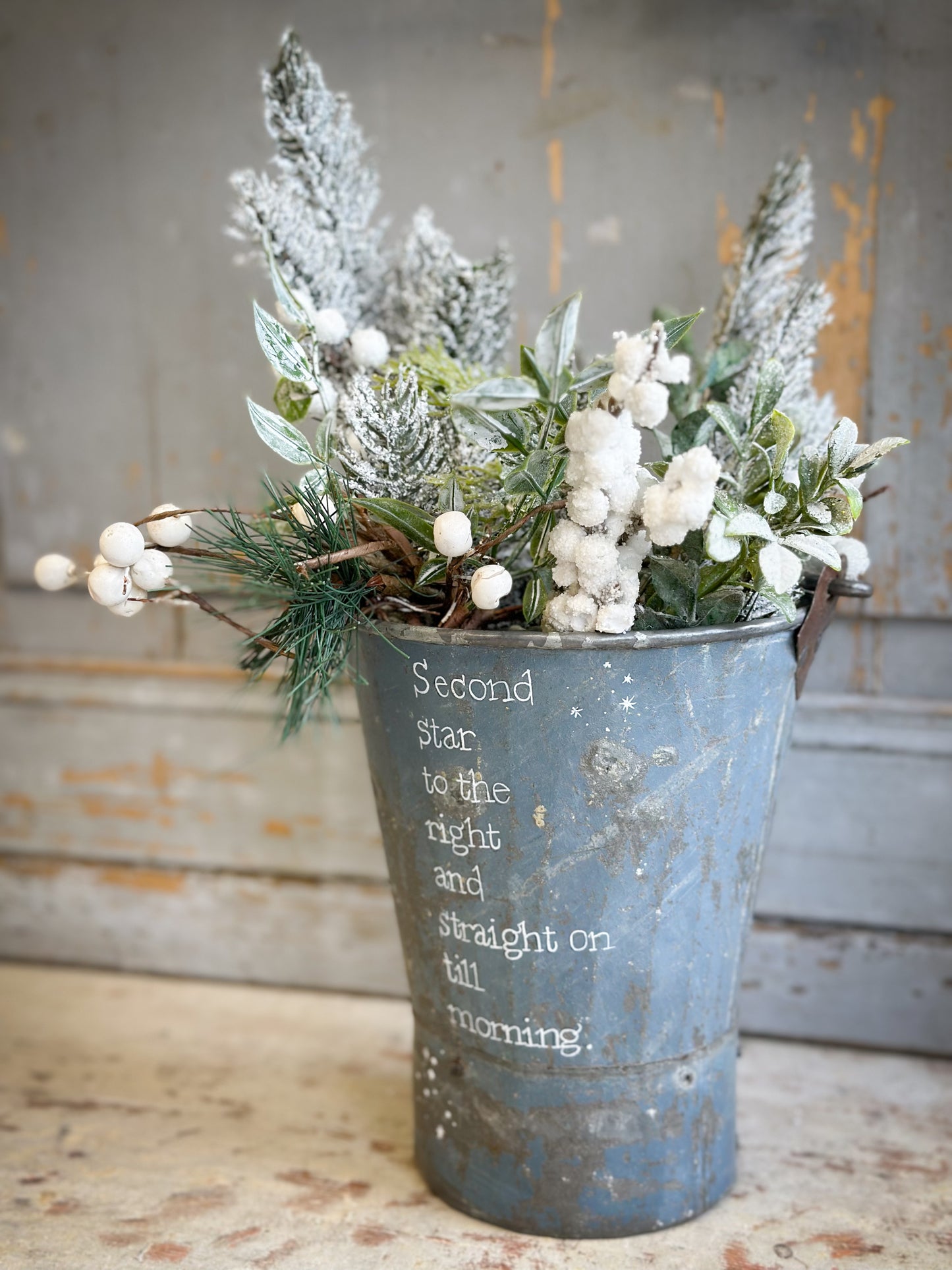 A Recycled Metal Mini Christmas Tree Bucket With A Hand Painted Quote