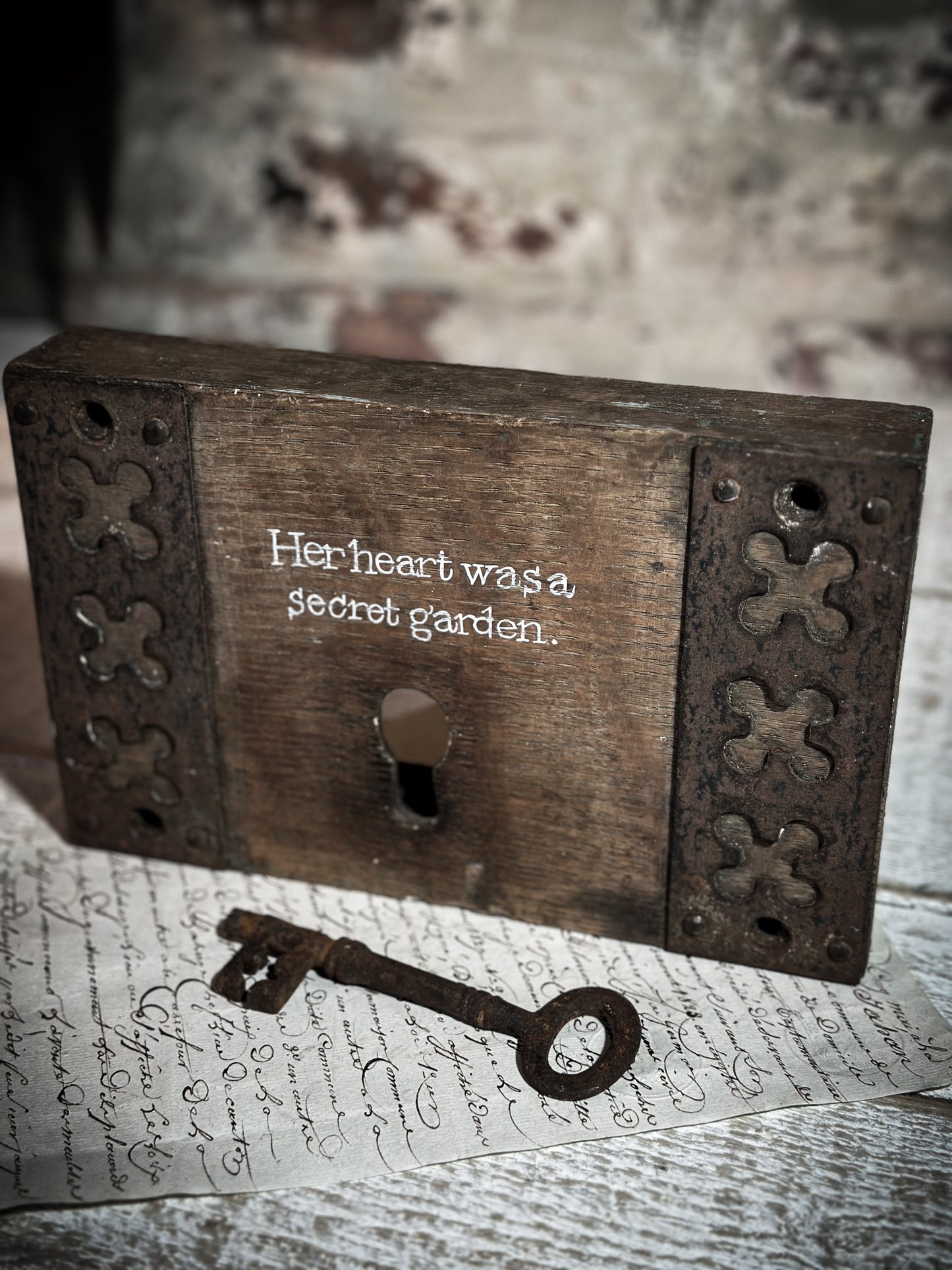 A salvaged original door lock with a painted quote