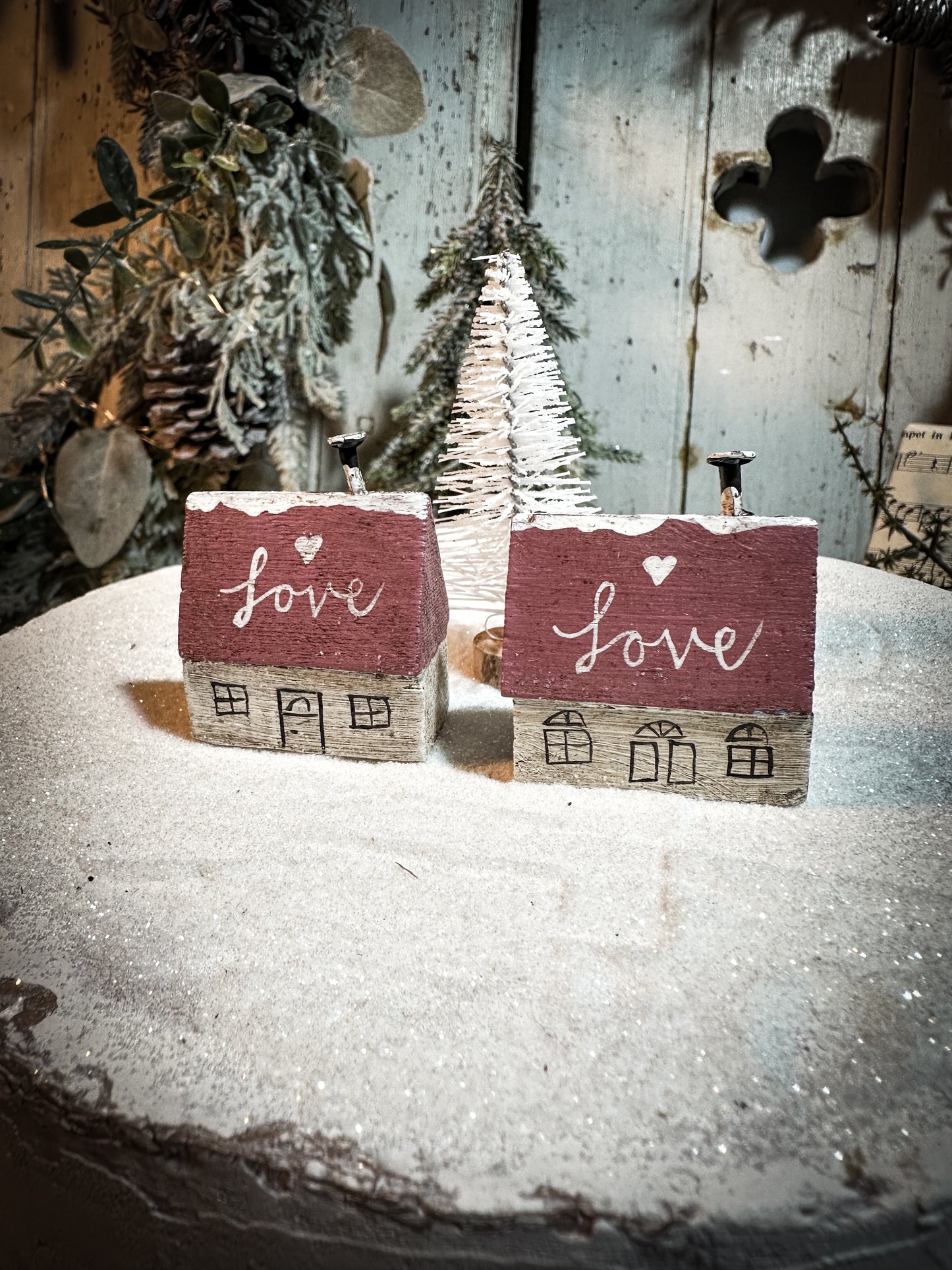 A pretty vintage German Erzgebirge Putz wooden village house painted with a Christmas quote