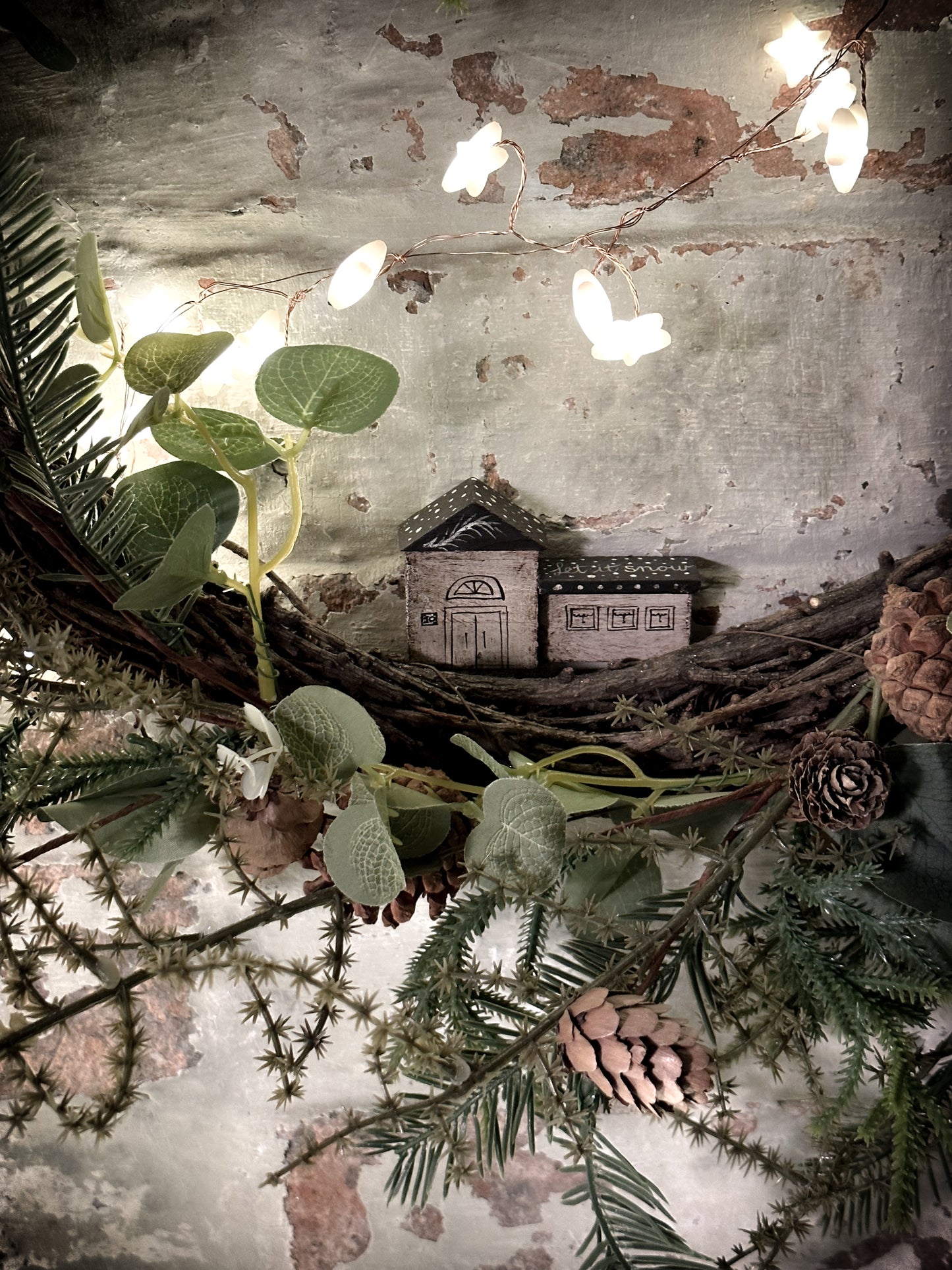 A pretty vintage German Erzgebirge Putz wooden village house painted with a Christmas quote