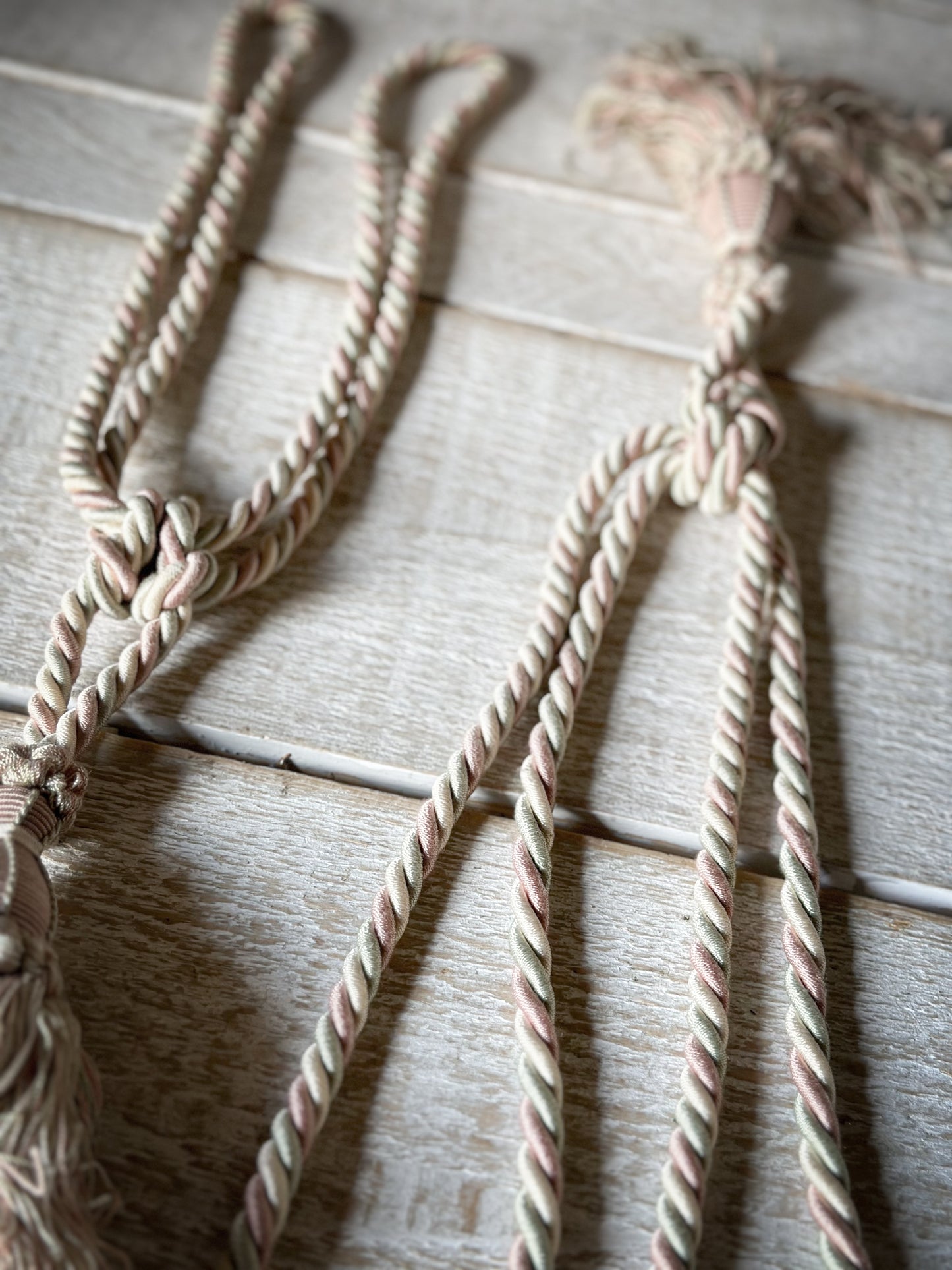 A pair of pretty vintage pastel pink, sage green and ivory curtain tie backs