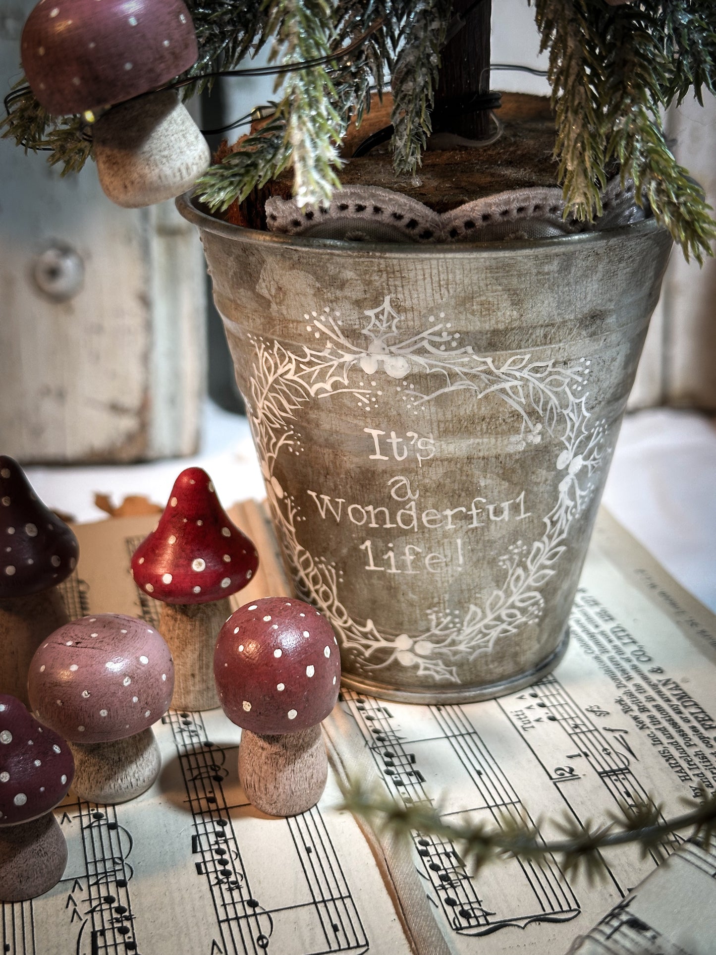 A wooden hand painted Christmas village toadstool