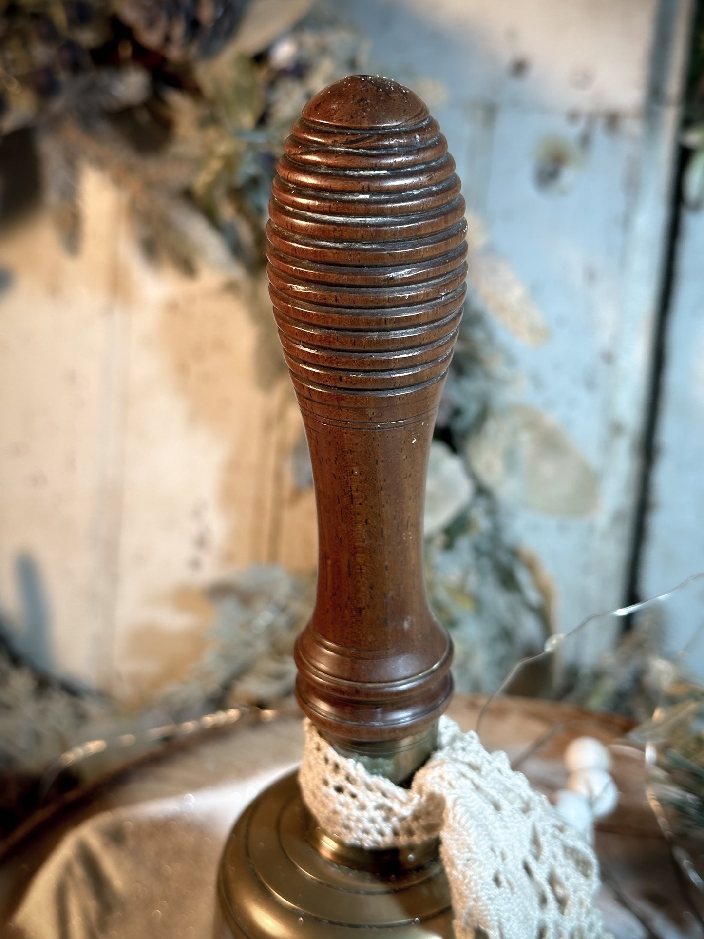 A vintage brass hand held bell with a hand painted quote