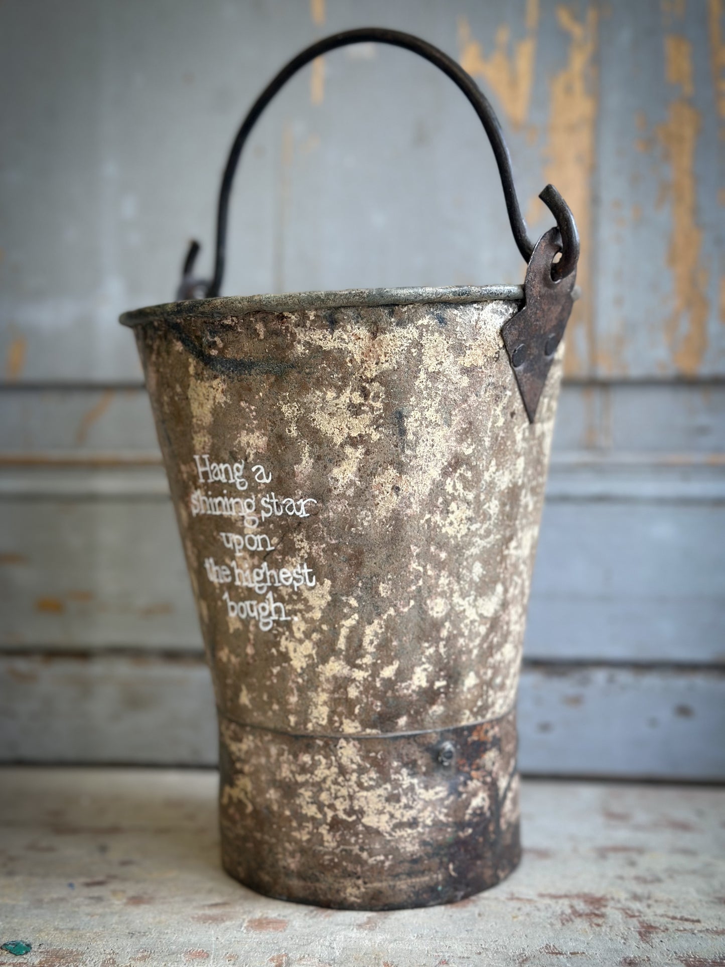 A Recycled Metal Mini Christmas Tree Bucket With A Hand Painted Quote