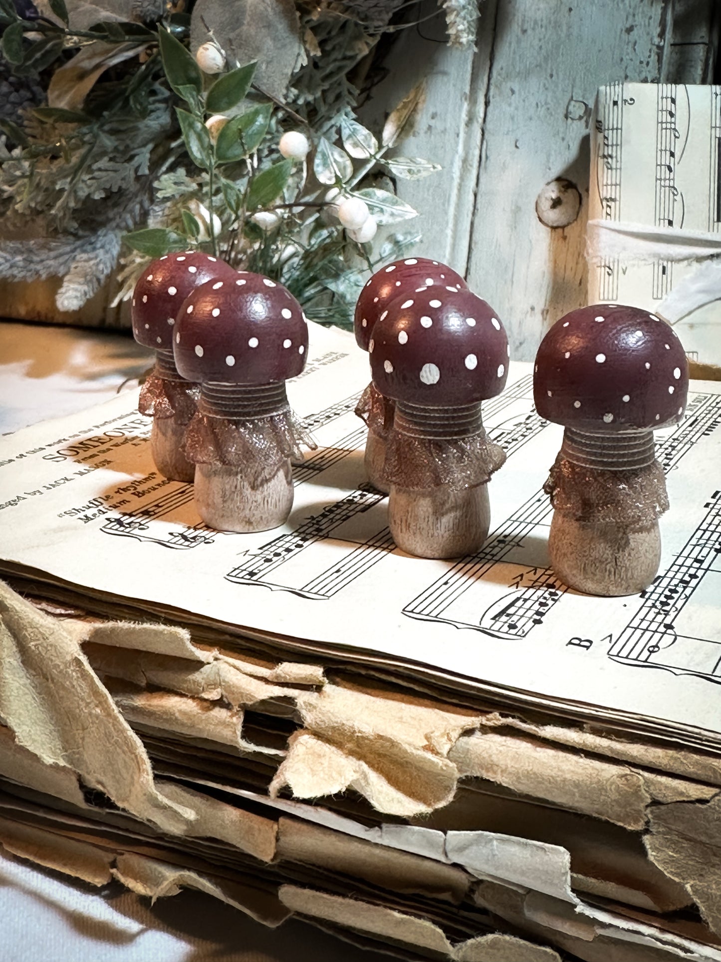 A wooden hand painted and trimmed Christmas village toadstool