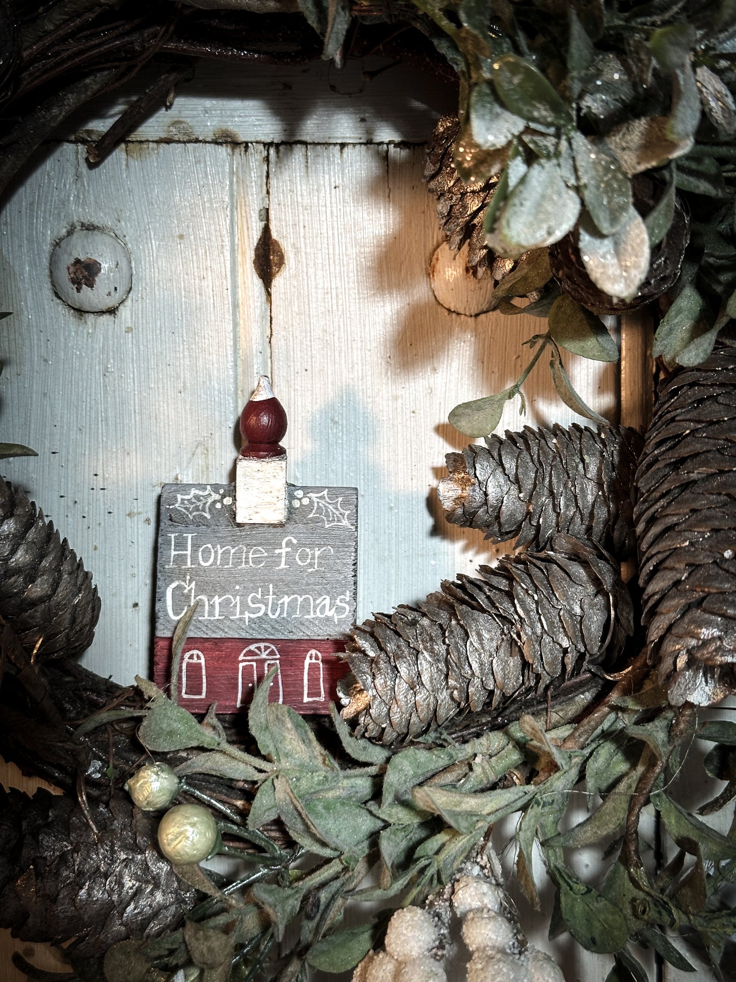 A pretty vintage German Erzgebirge Putz wooden village house painted with a Christmas quote