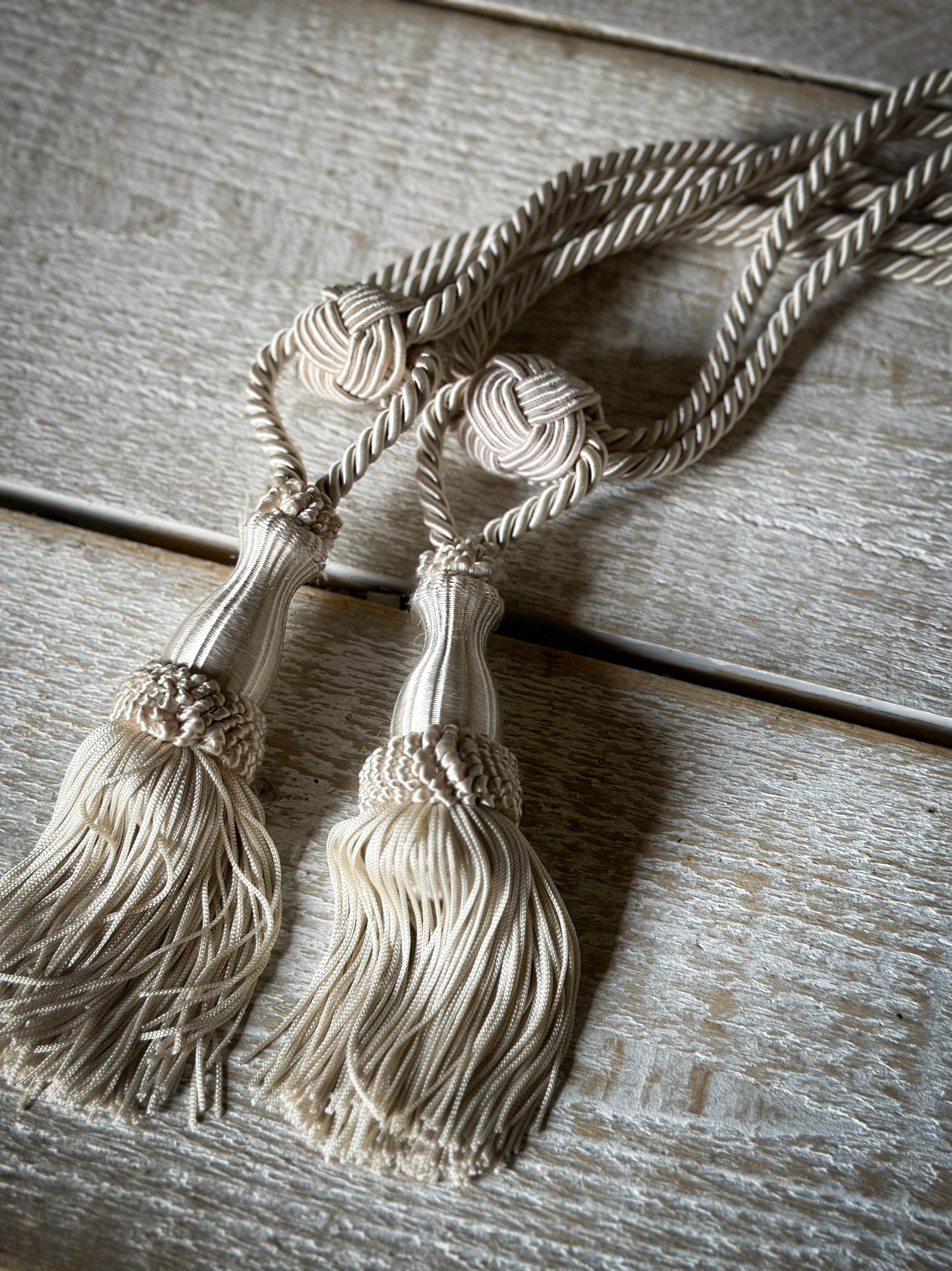 A pair of pretty vintage ivory curtain tie backs