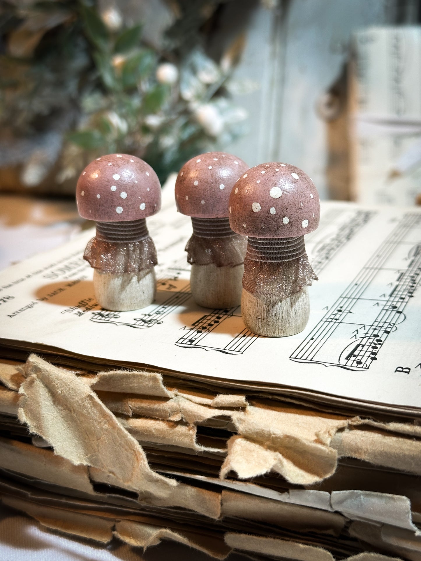 A wooden hand painted and trimmed Christmas village toadstool