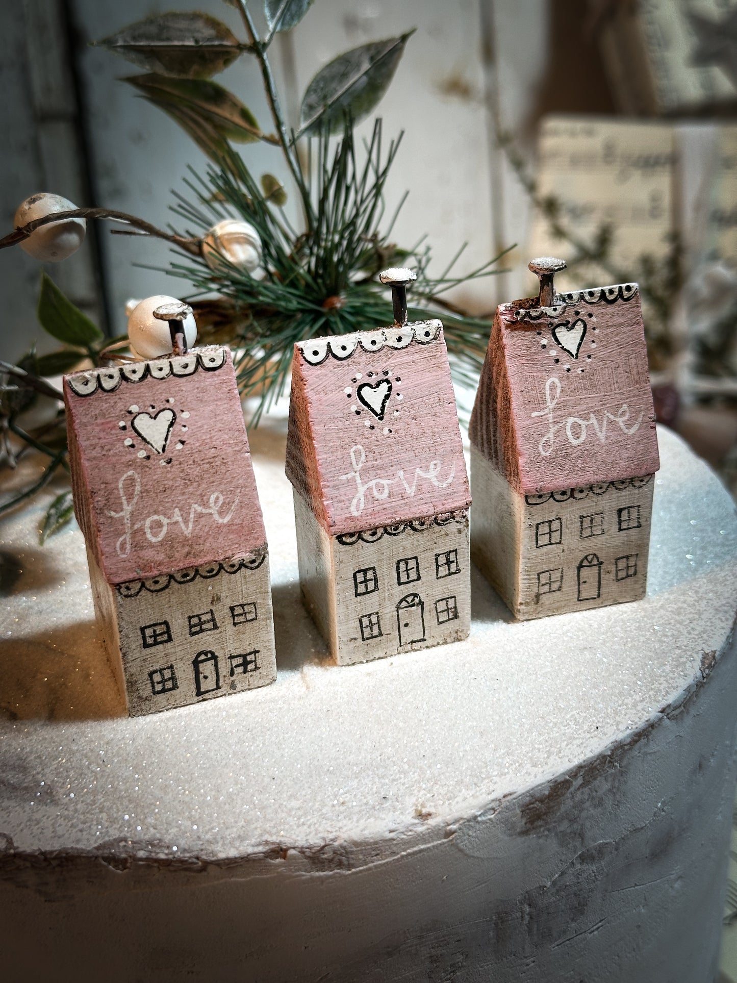 A pretty vintage German Erzgebirge Putz wooden village house painted with a Christmas quote