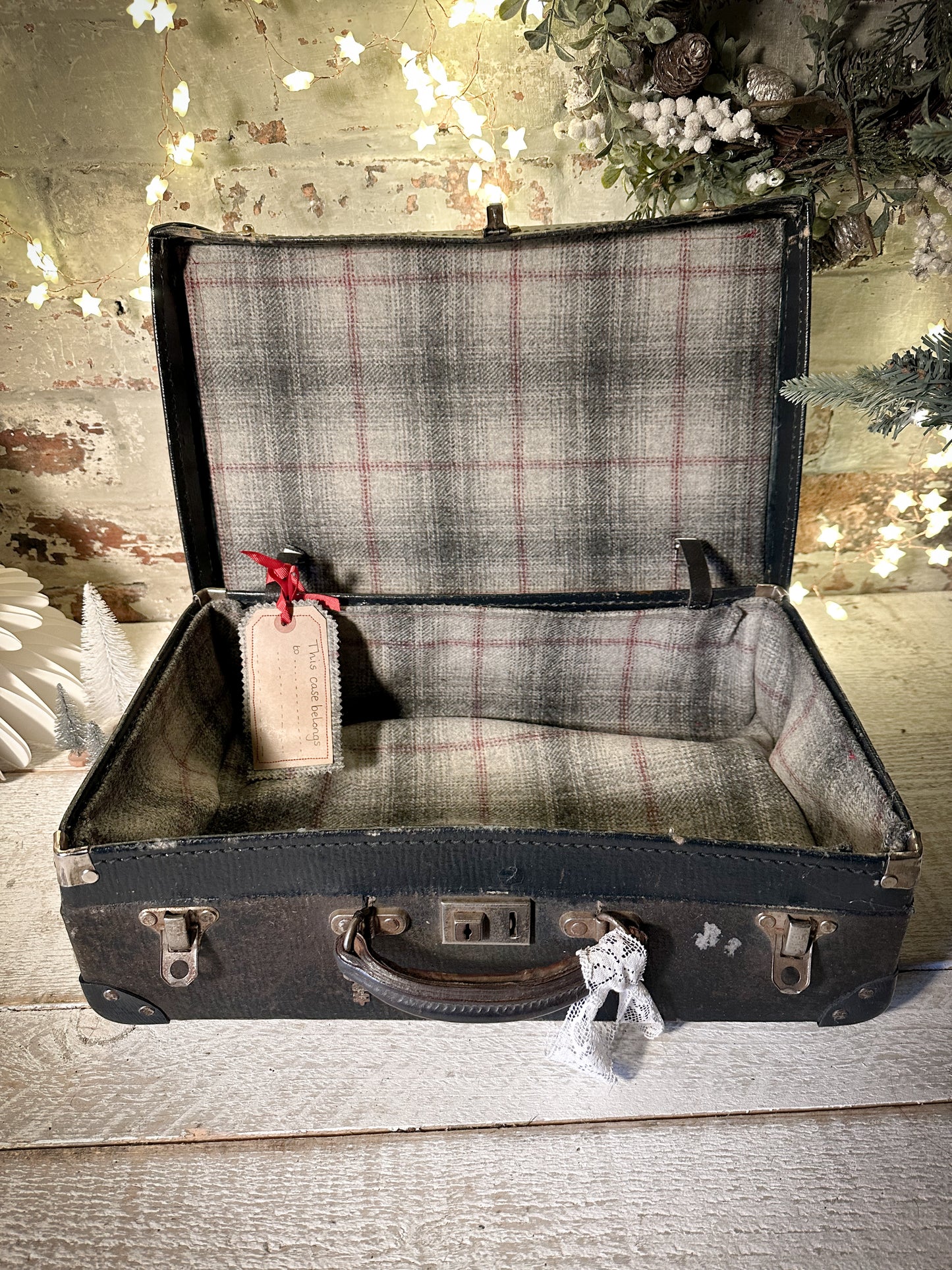 A gorgeous vintage suitcase with a hand painted quote for storing Christmas decorations