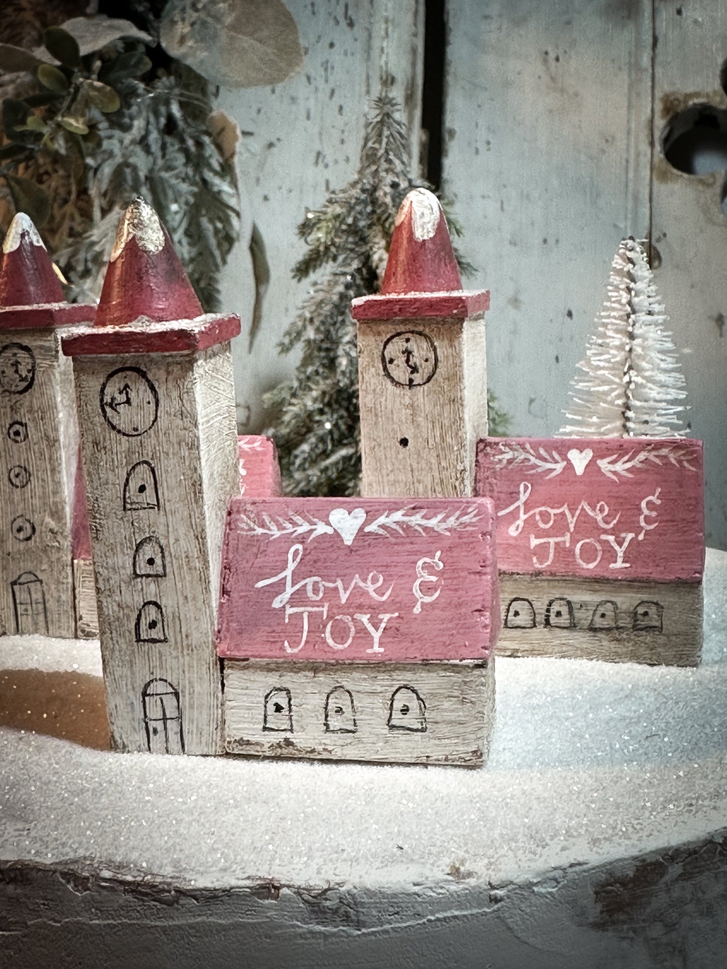 A pretty vintage German Erzgebirge Putz wooden village house painted with a Christmas quote