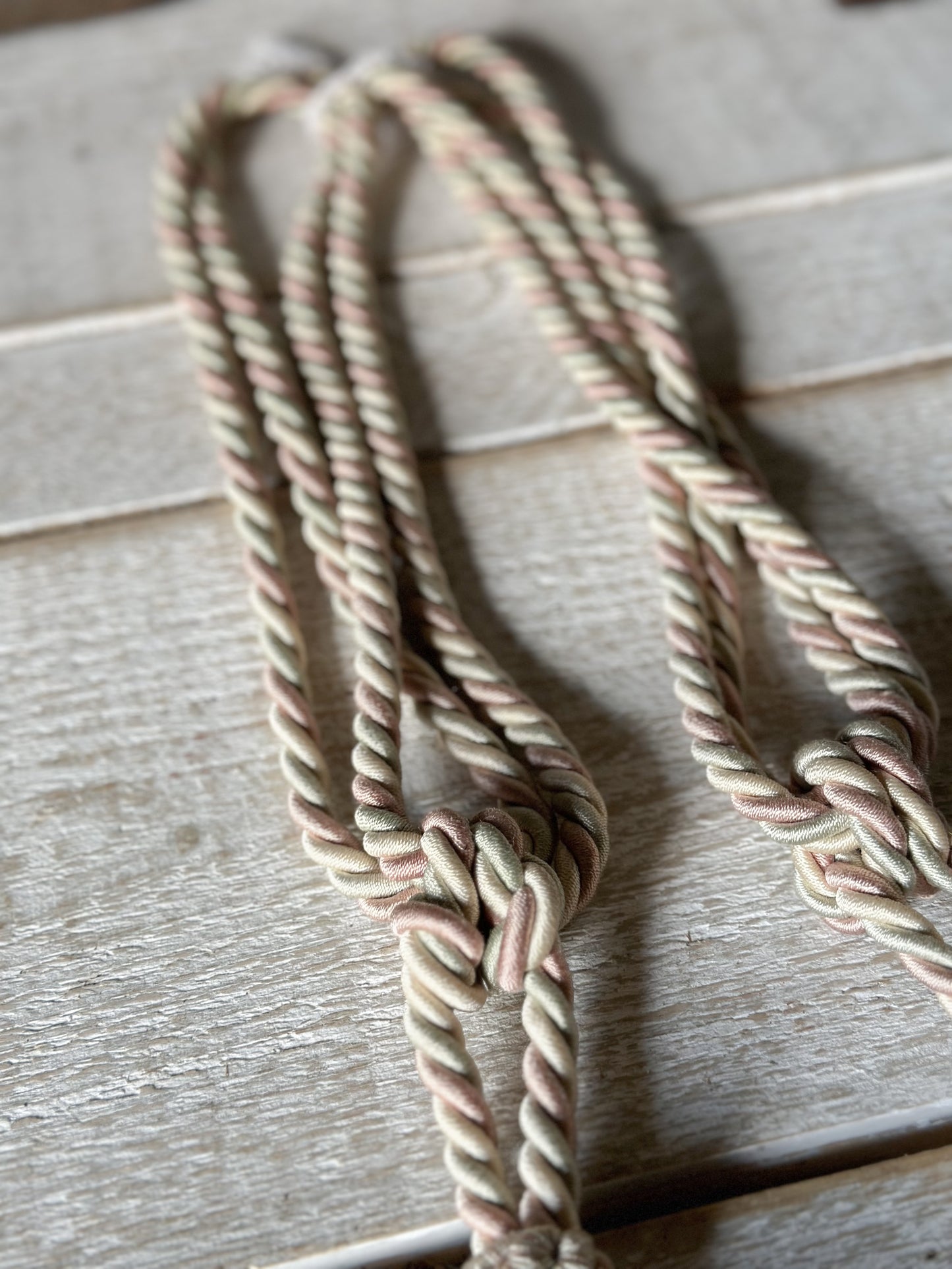 A pair of pretty vintage pastel pink, sage green and ivory curtain tie backs